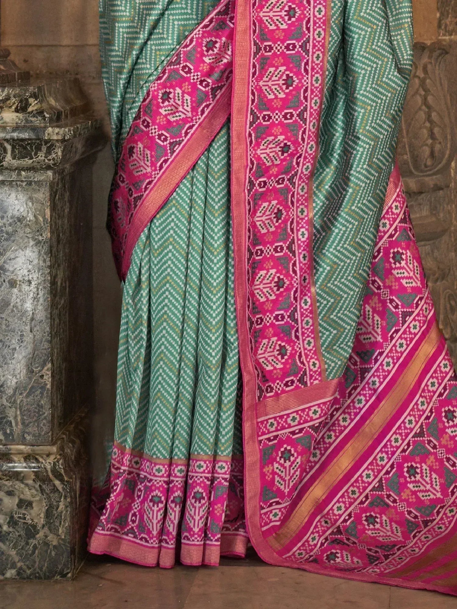 Green and pink ethnic saree with geometric patterns, perfect for Indian traditional wear