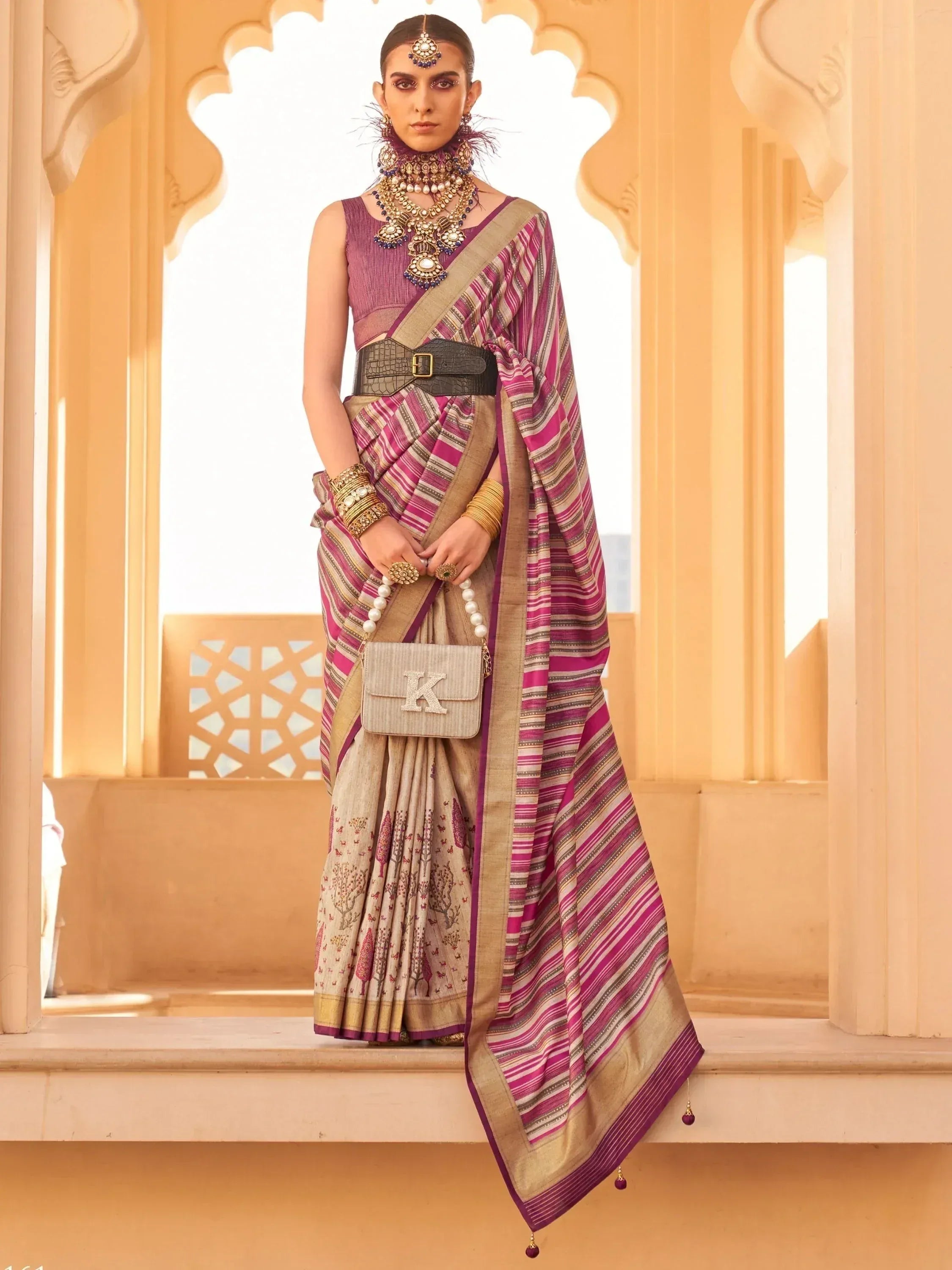 Woman in purple and beige striped saree with temple jewelry, styled for Indian ethnic wear