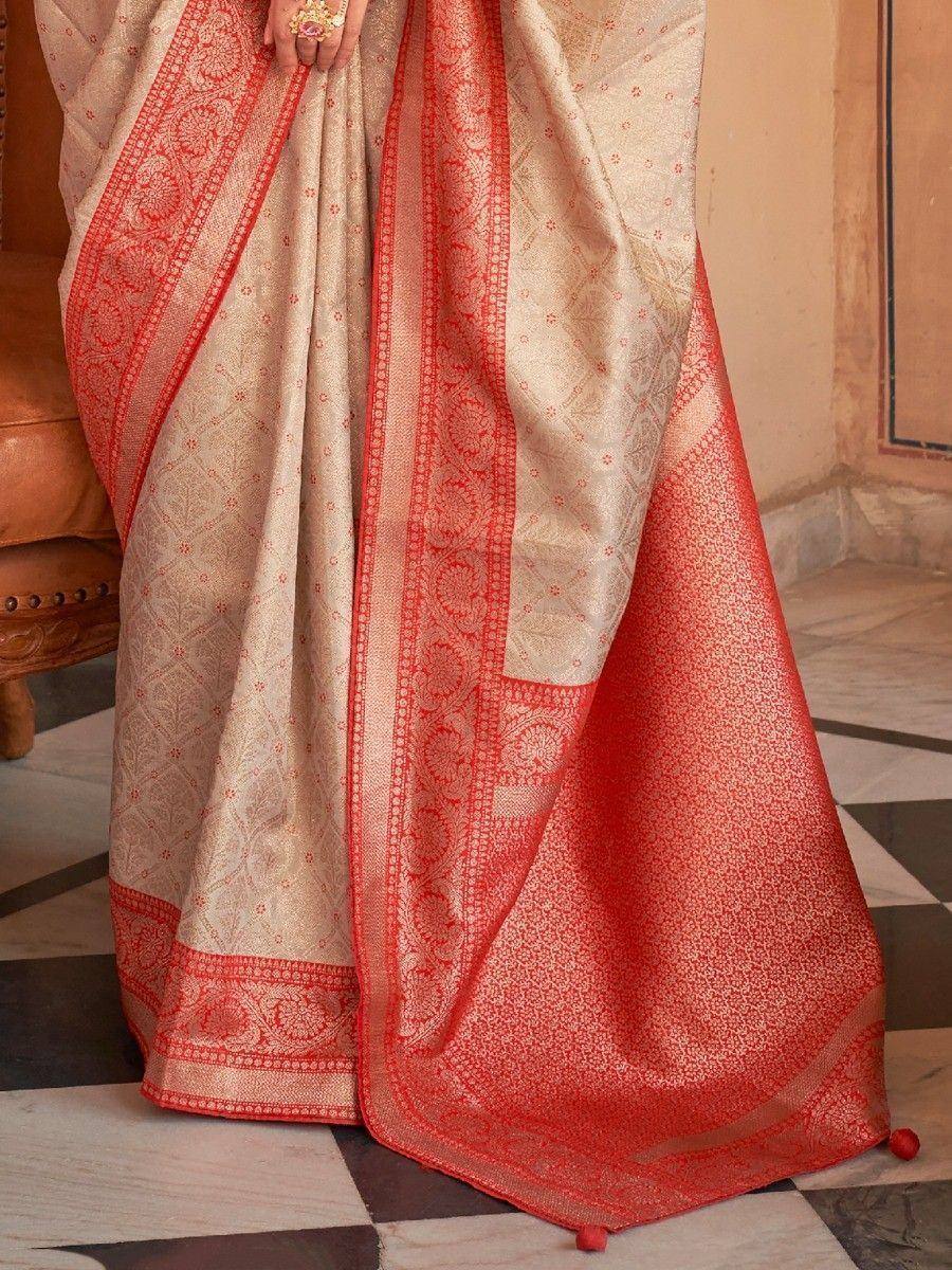 Cream and coral designer saree with intricate floral border, perfect for Indian ethnic occasions