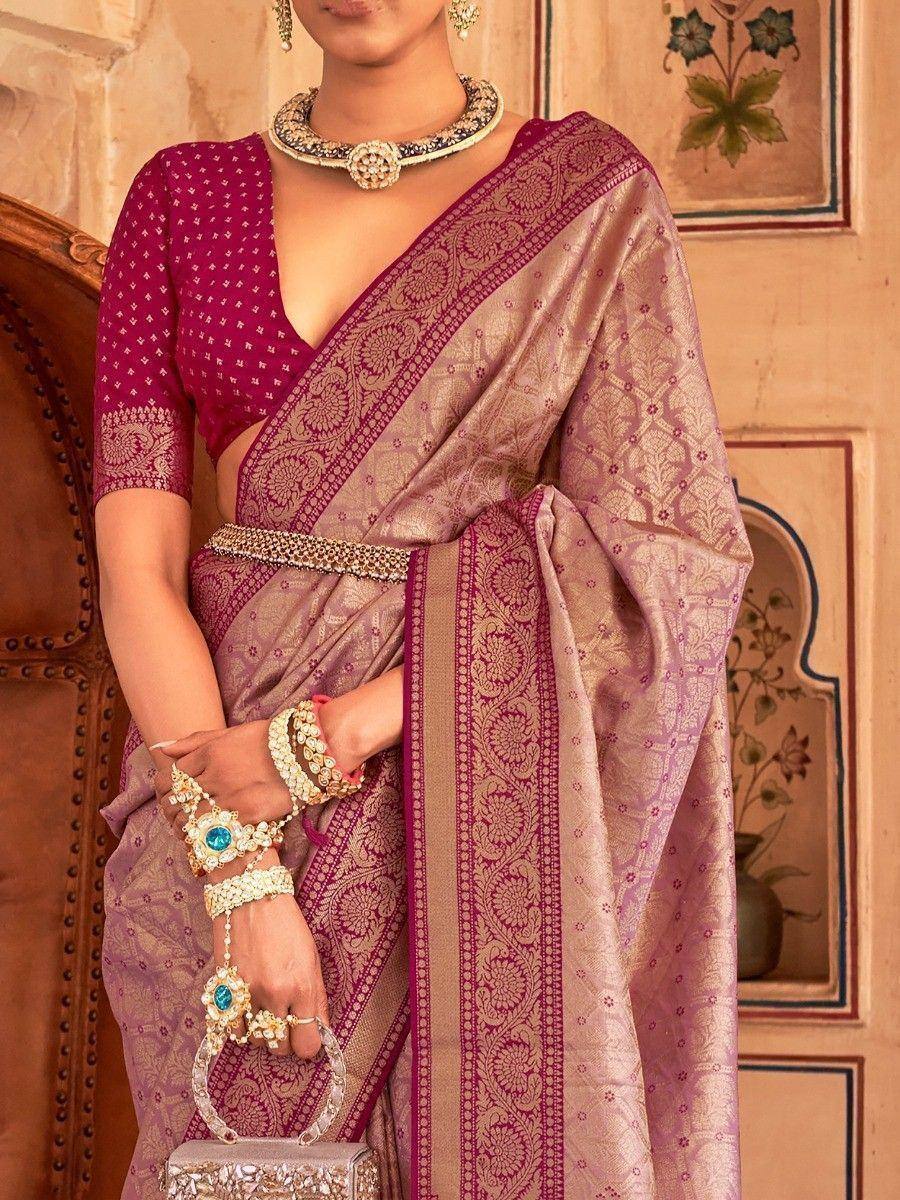 Elegant purple and gold Banarasi saree with intricate embroidery, paired with designer jewelry for festive occasions