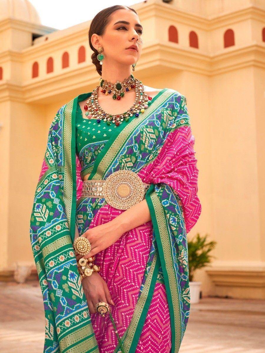 Vibrant pink and green printed saree with ethnic jewelry, perfect for Indian festive occasions