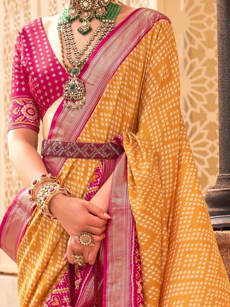 Yellow and pink ethnic saree with intricate jewelry, perfect for Indian weddings or festive occasions.