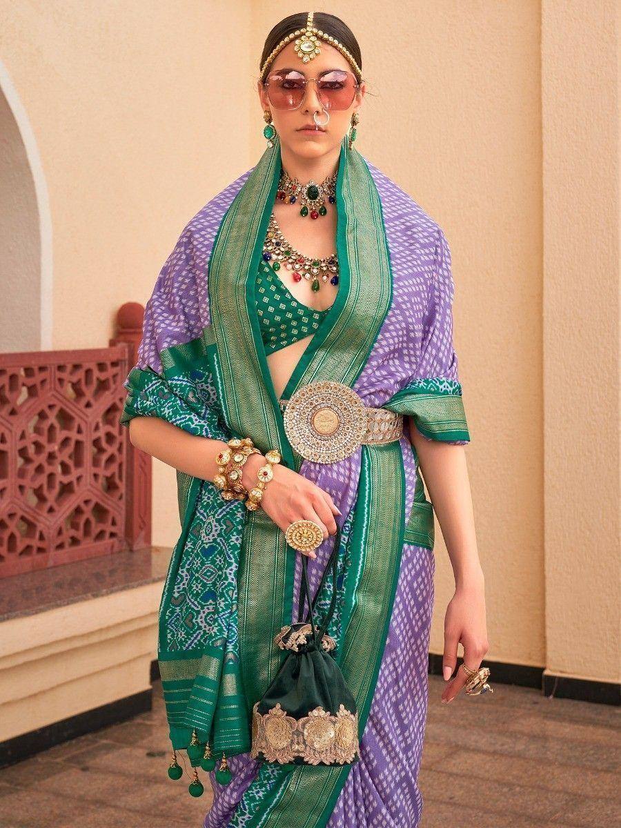 Purple and green designer saree with gold belt, ethnic jewelry, and traditional Indian attire