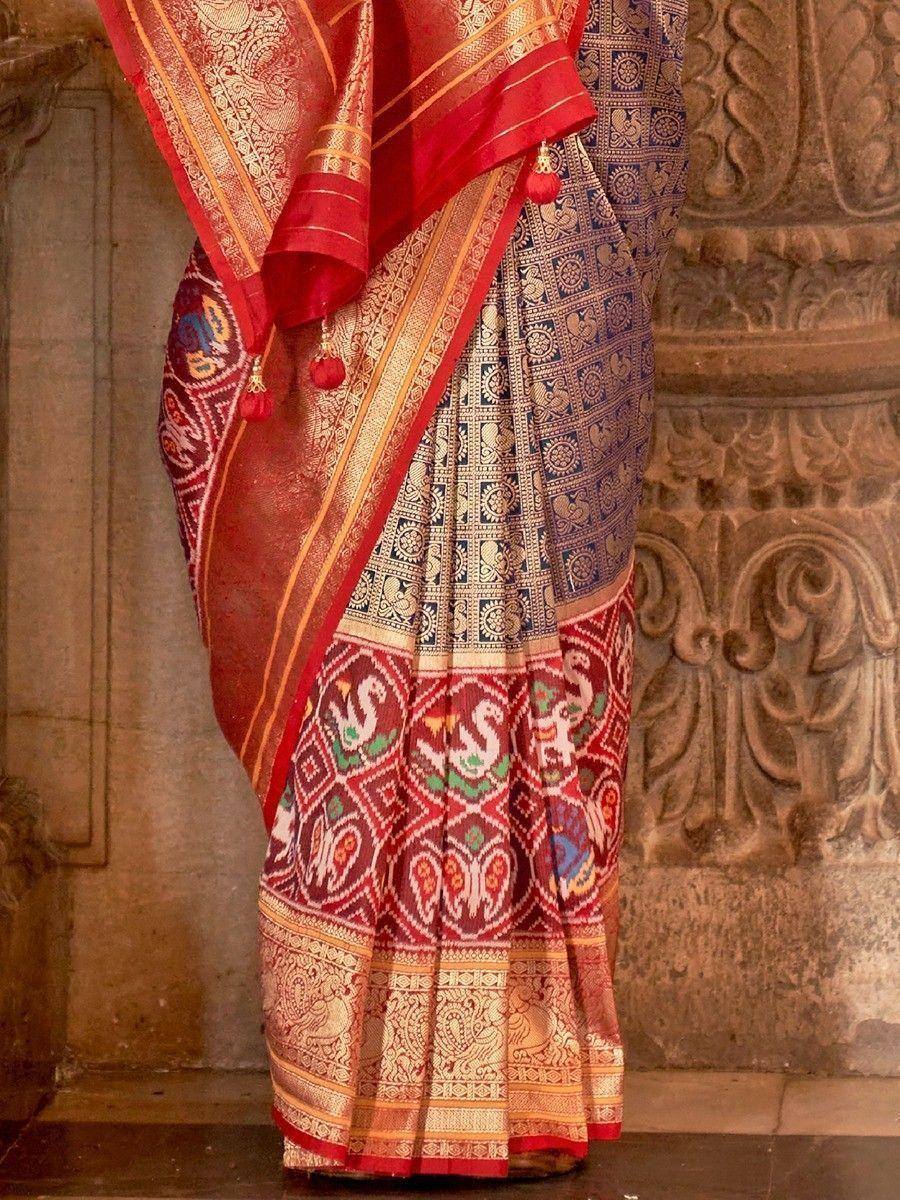 Red and blue designer saree with intricate gold patterns and tassels, perfect for ethnic occasions