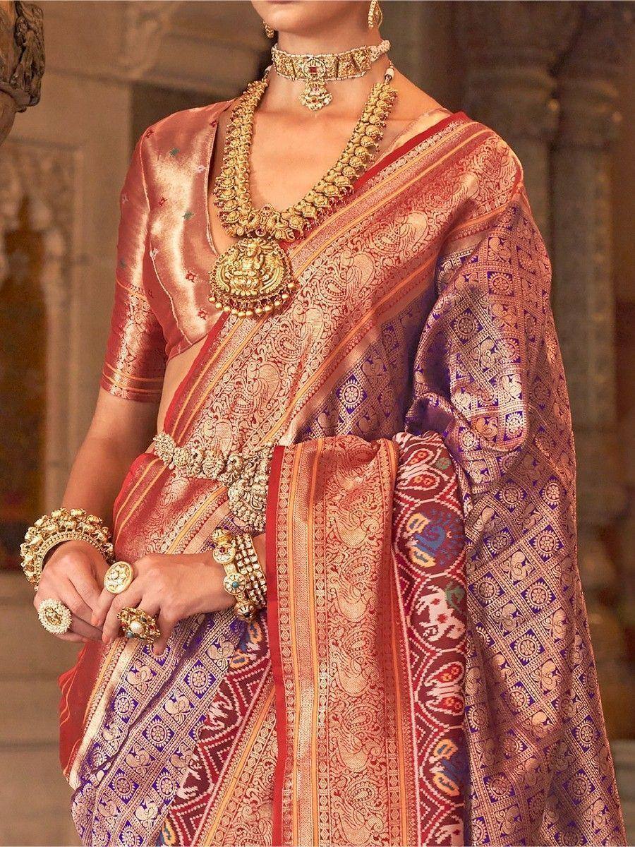 Luxury Indian saree with intricate gold embroidery, paired with heavy traditional jewelry for weddings