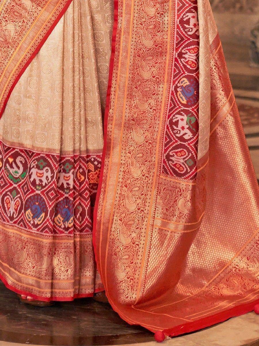 Elegant Indian saree with intricate elephant and peacock motifs, rich red and gold borders, traditional ethnic wear