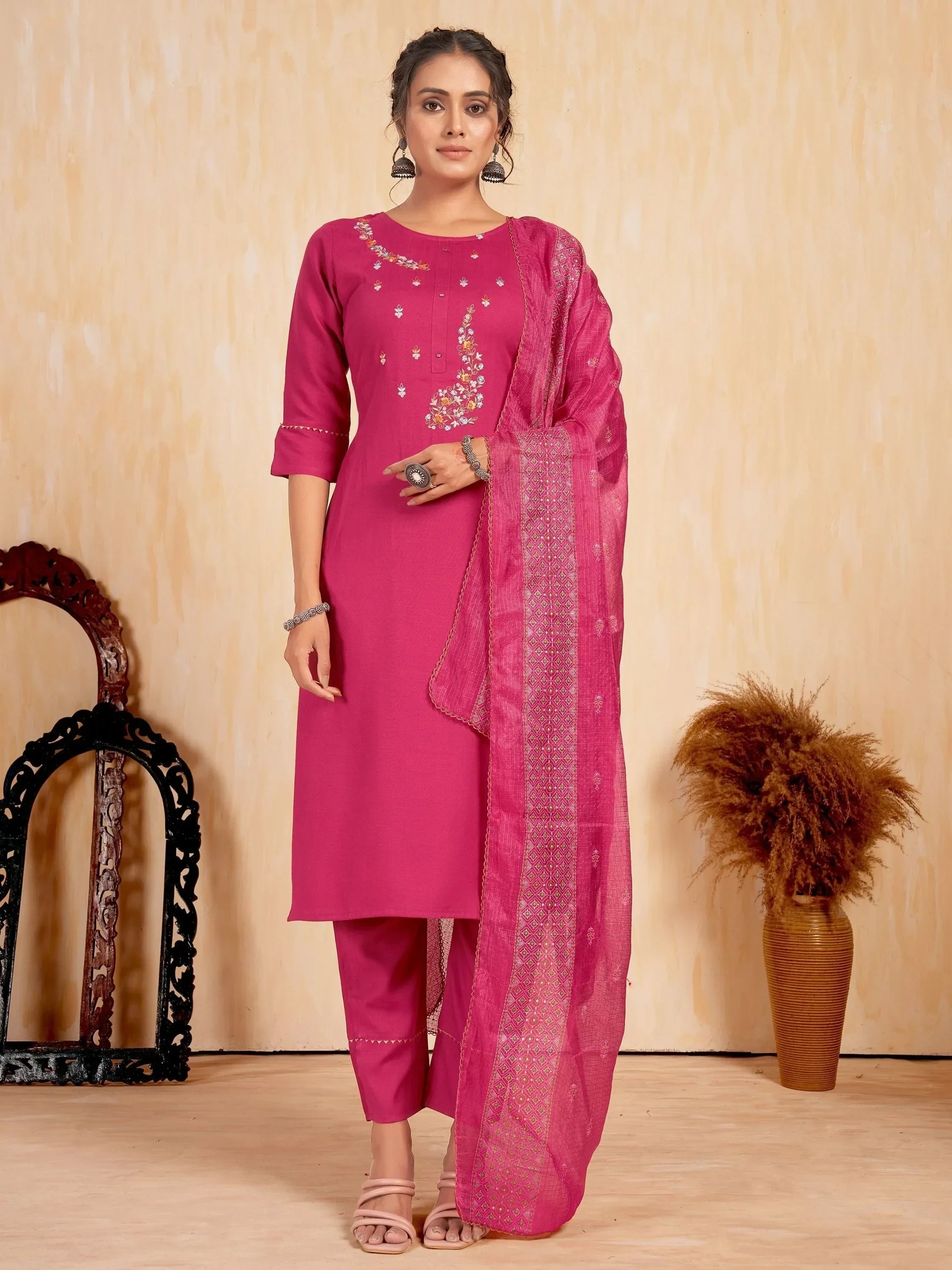 Woman wearing magenta embroidered salwar kameez with matching dupatta, traditional Indian outfit