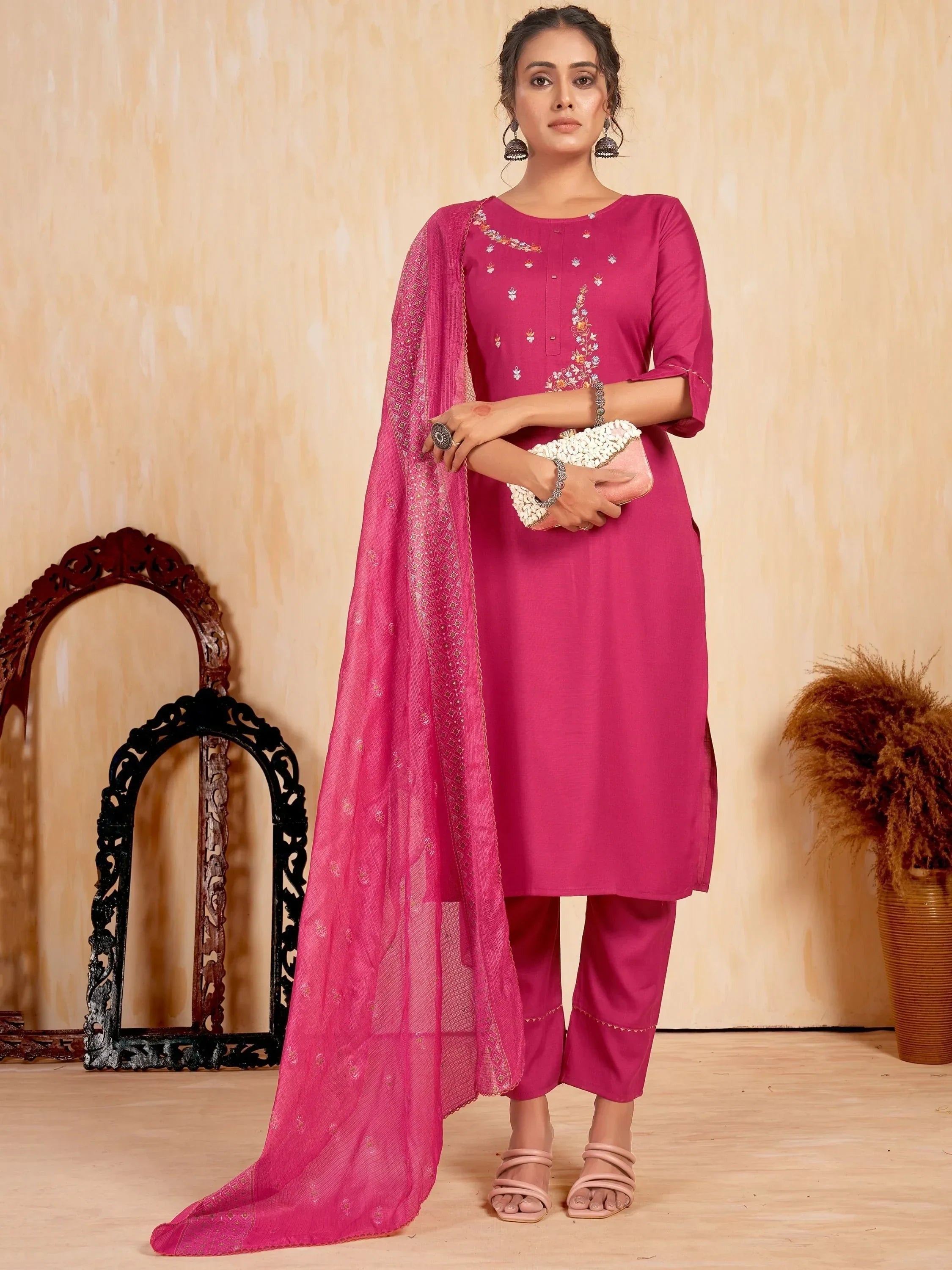 Woman in magenta embroidered salwar kameez with matching dupatta, styled for ethnic wear