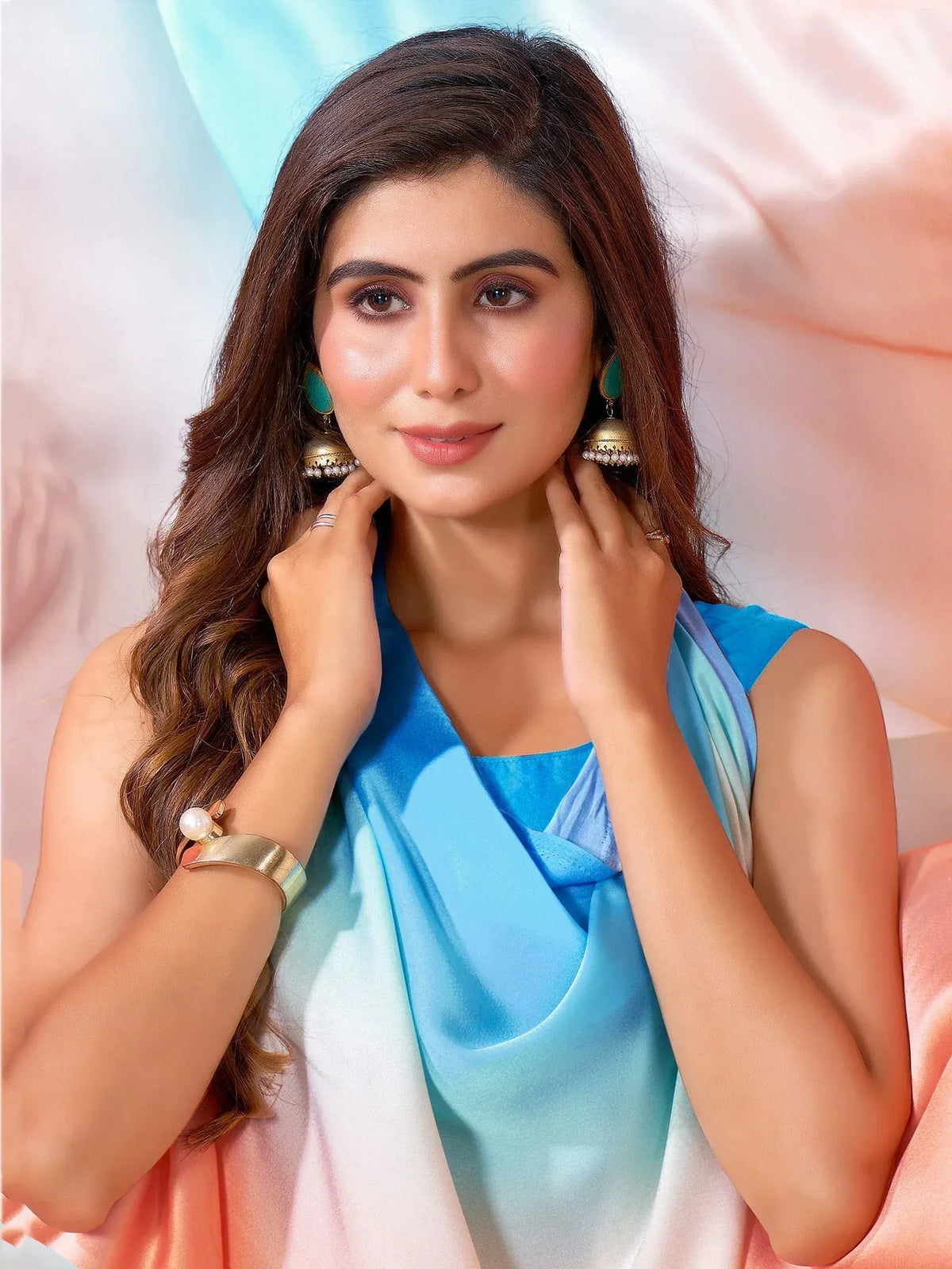 Woman in blue ethnic gown with ombre dupatta and jhumka earrings, perfect for Indian occasions