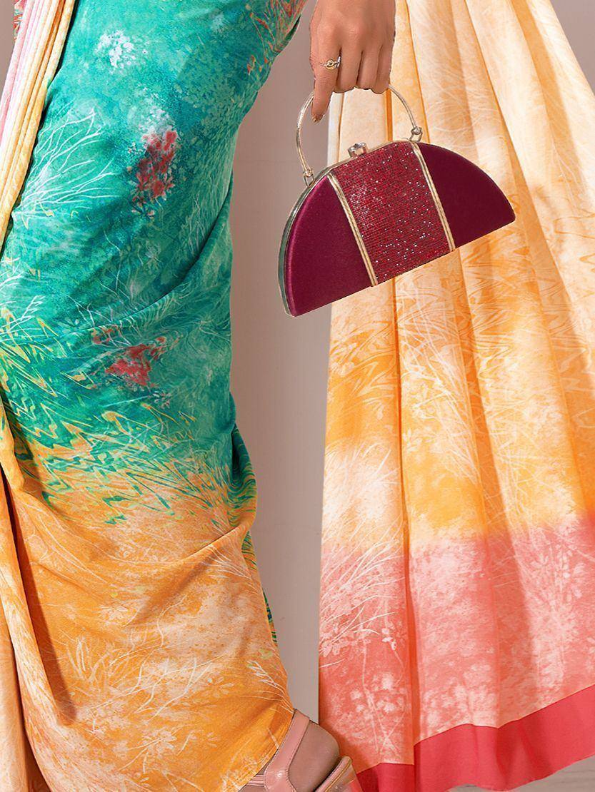 Woman in vibrant green and orange printed saree with red embellished clutch, ethnic wear fashion