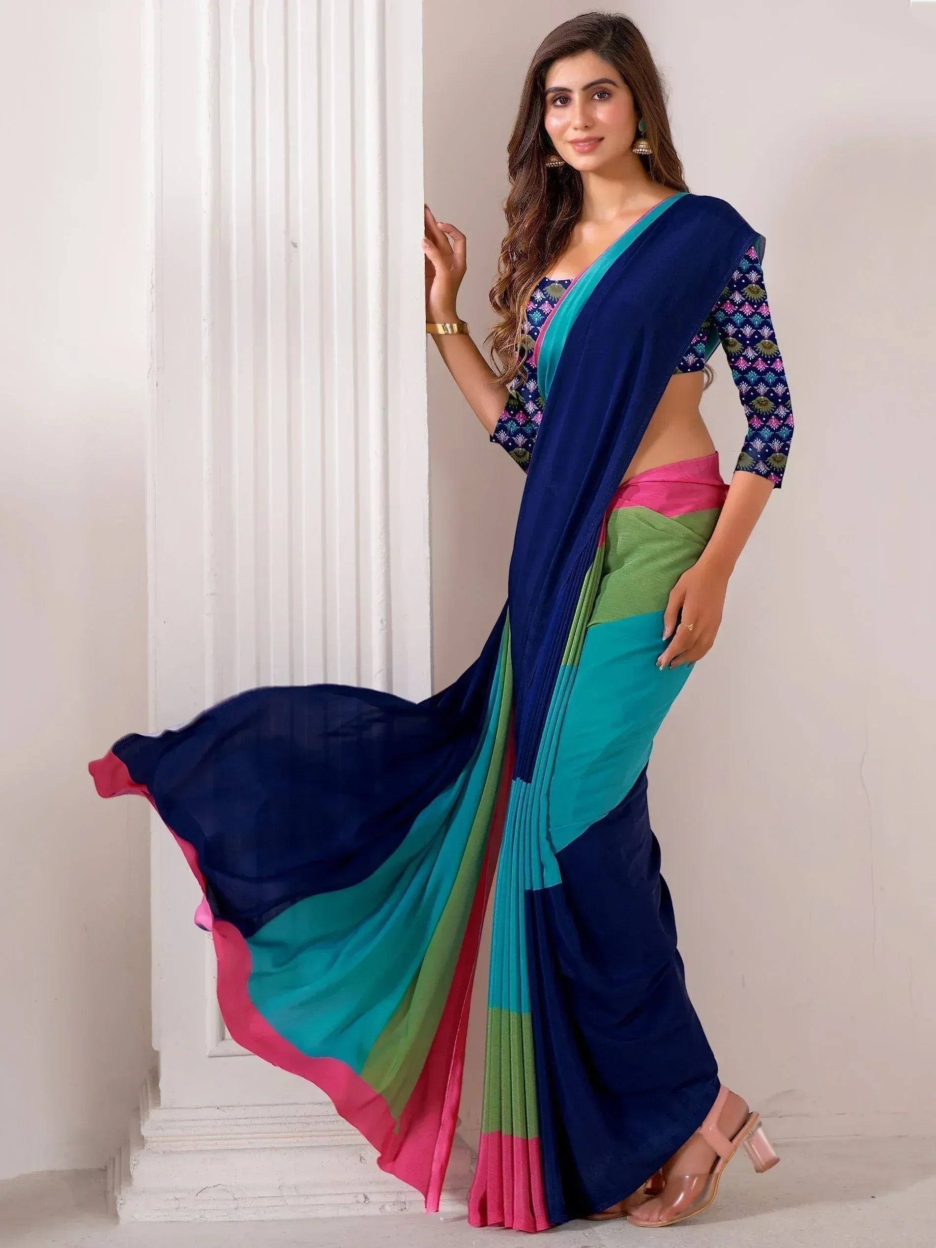Woman in vibrant multicolor saree with blue, green, pink panels and printed blouse, ethnic Indian wear