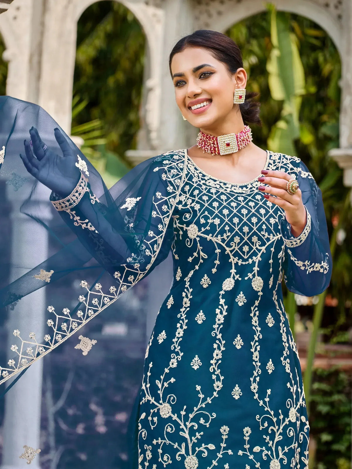 Elegant teal ethnic gown with gold embroidery, perfect for Indian weddings and festive occasions.