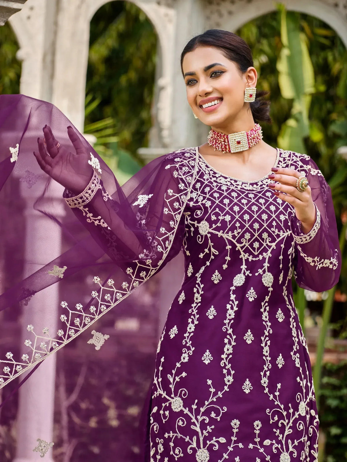 Elegant purple embroidered ethnic gown with sheer sleeves and floral detailing, perfect for Indian occasions.