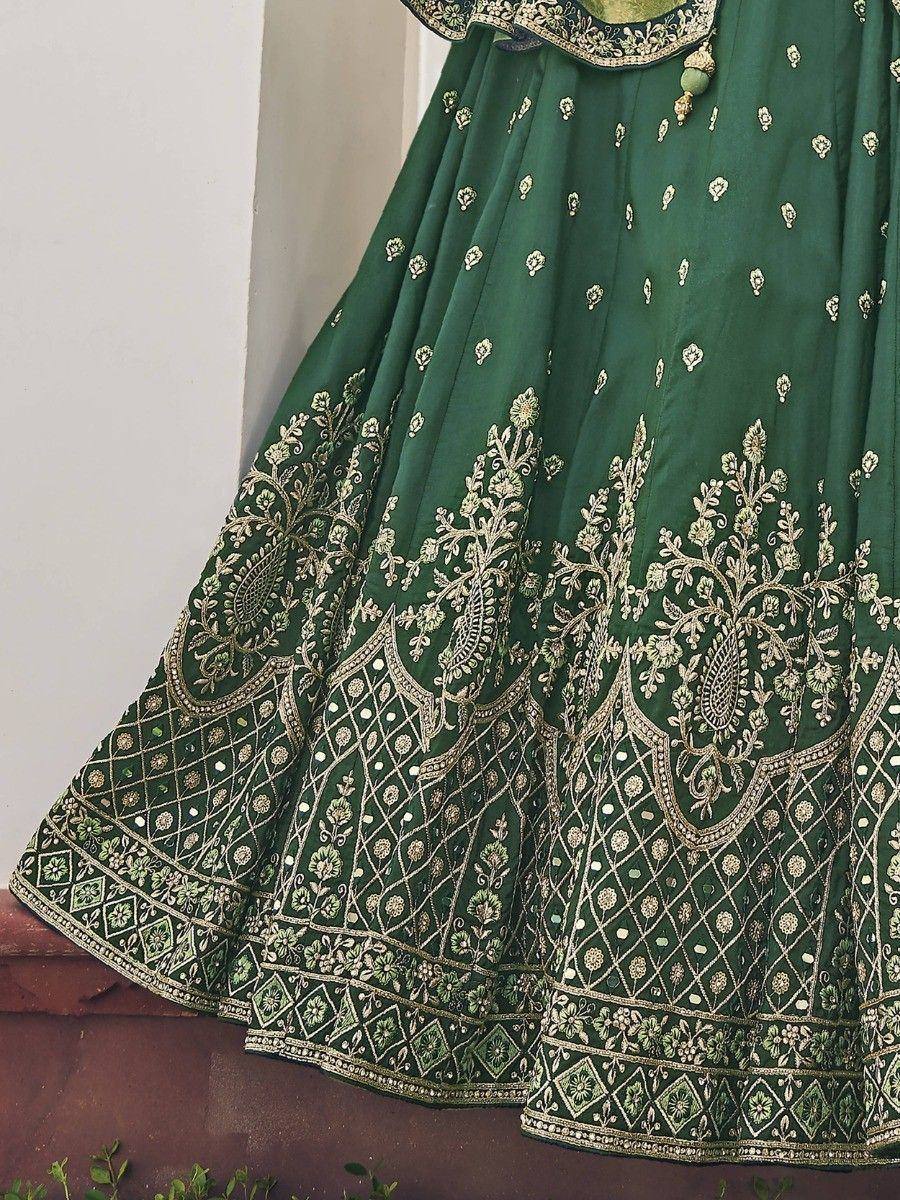 Emerald green lehenga with gold floral embroidery and intricate border detailing, perfect for Indian ethnic wear.