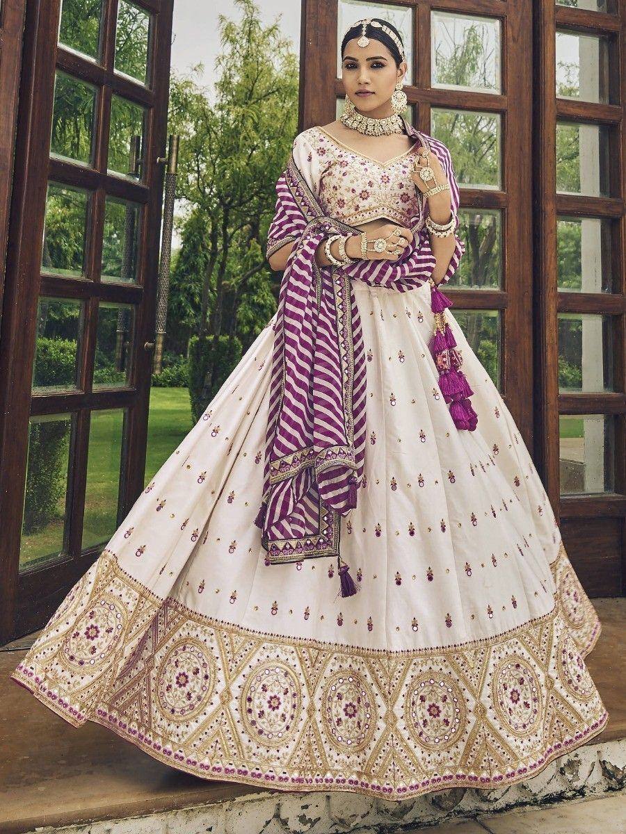 Elegant white and purple lehenga choli with intricate embroidery, perfect for Indian weddings and festive occasions.