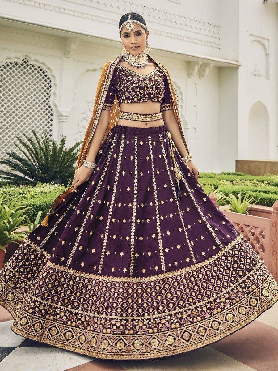 Purple designer lehenga choli with gold embroidery, perfect for Indian weddings and festive occasions.