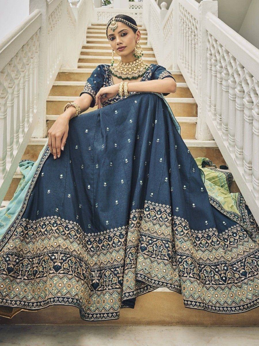Elegant navy blue lehenga choli with intricate gold embroidery, perfect for Indian ethnic wear occasions.