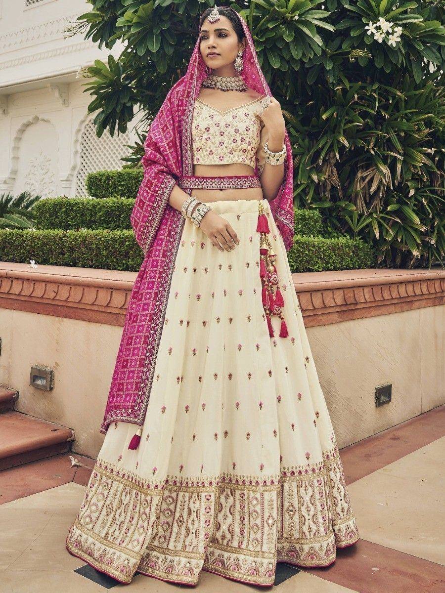 Cream and pink embroidered lehenga choli with dupatta, perfect for Indian weddings and festive occasions.
