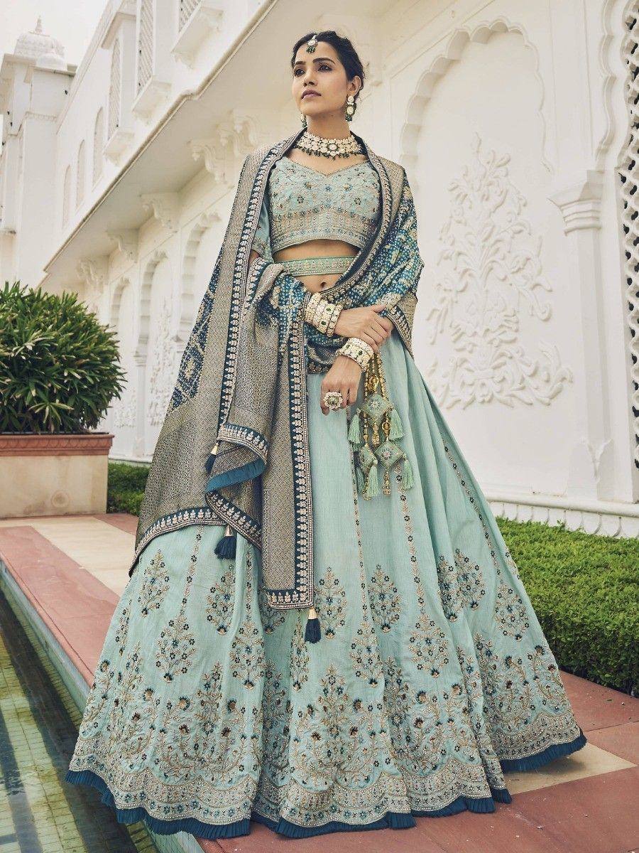 Elegant mint green designer lehenga choli with intricate embroidery, perfect for Indian weddings and festive occasions.
