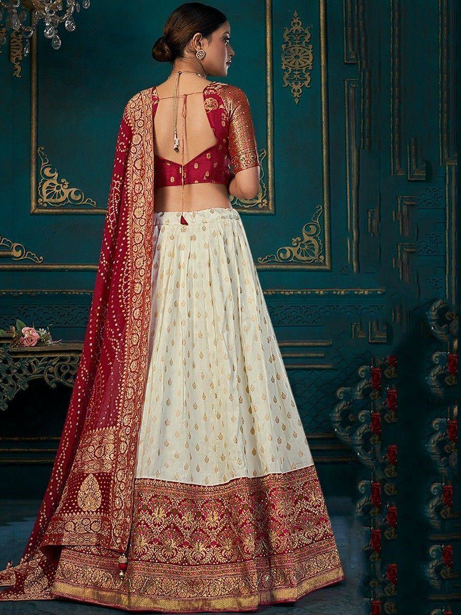 Red and cream embroidered lehenga choli with backless blouse and dupatta, perfect for Indian weddings