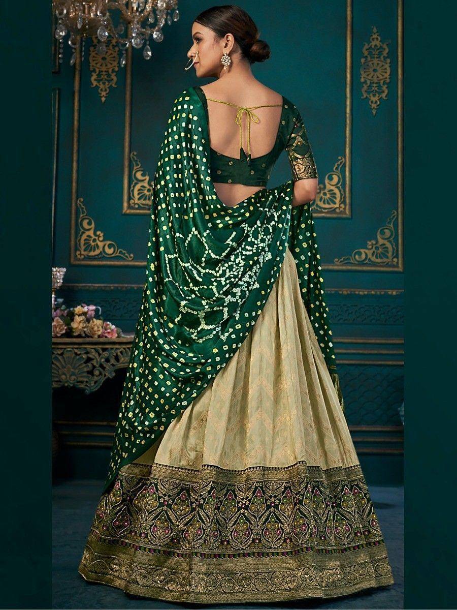 Green and gold designer lehenga choli with embroidered dupatta, ethnic Indian wear for weddings