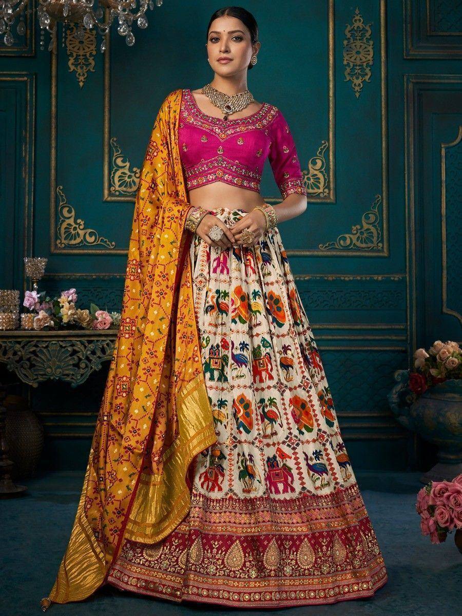 Vibrant Indian lehenga choli with elephant print skirt, pink blouse, and yellow dupatta for festive occasions