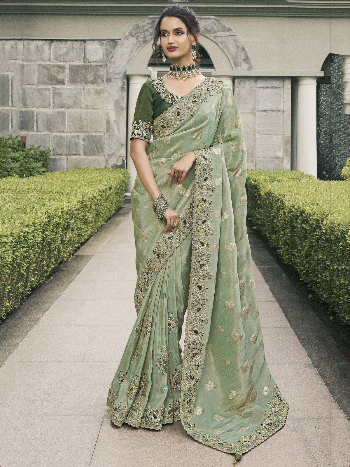 Elegant green designer saree with gold embroidery, perfect for Indian ethnic wear occasions.