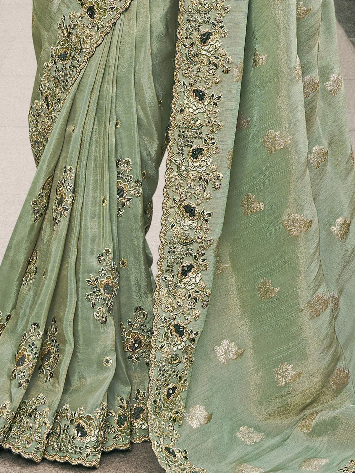 Sage green designer saree with gold floral embroidery and embellished border for ethnic wear