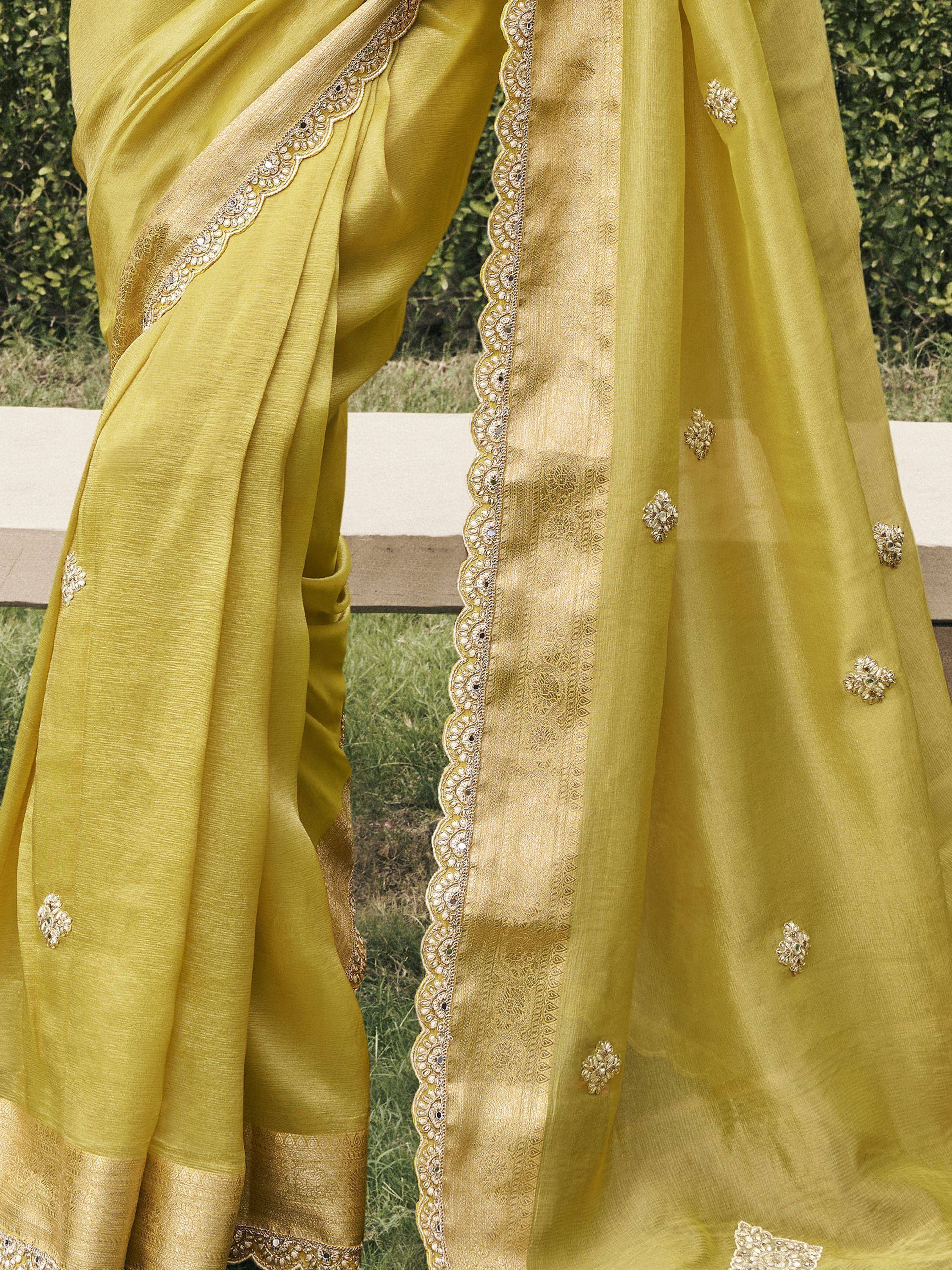 Yellow designer saree with gold embroidery and scalloped border, perfect for ethnic occasions