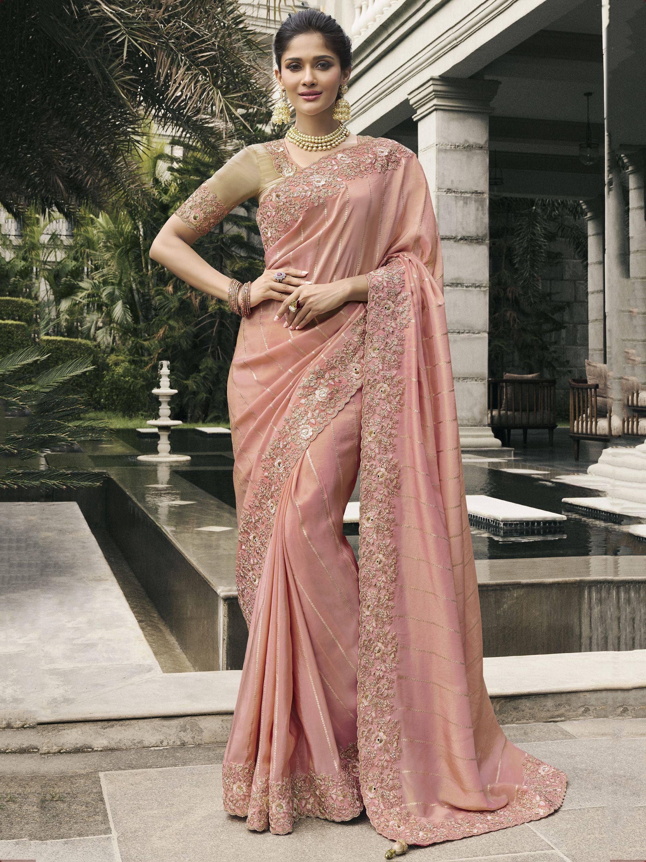 Elegant pink embroidered saree with gold detailing, perfect for Indian ethnic occasions and weddings.