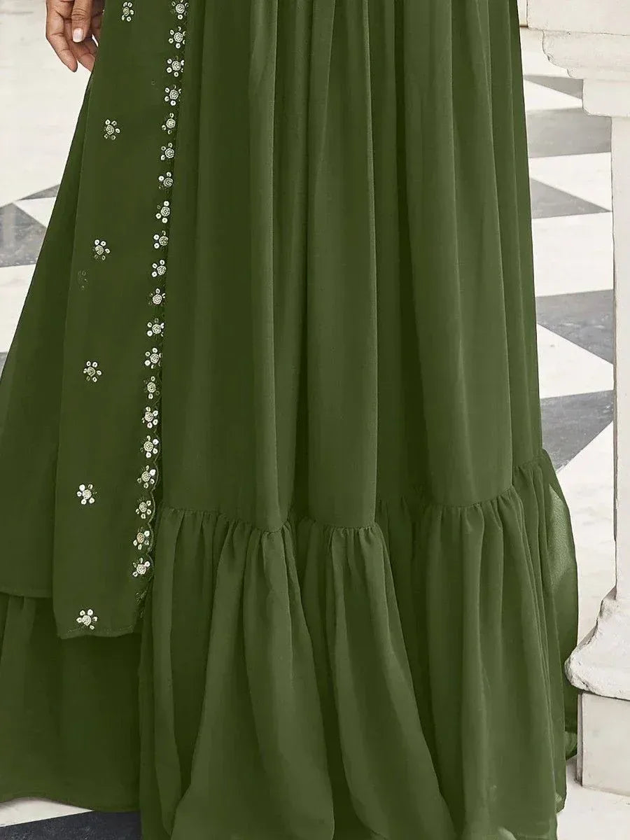 Olive green ethnic gown with floral embroidery and ruffled hem, perfect for Indian festive occasions.