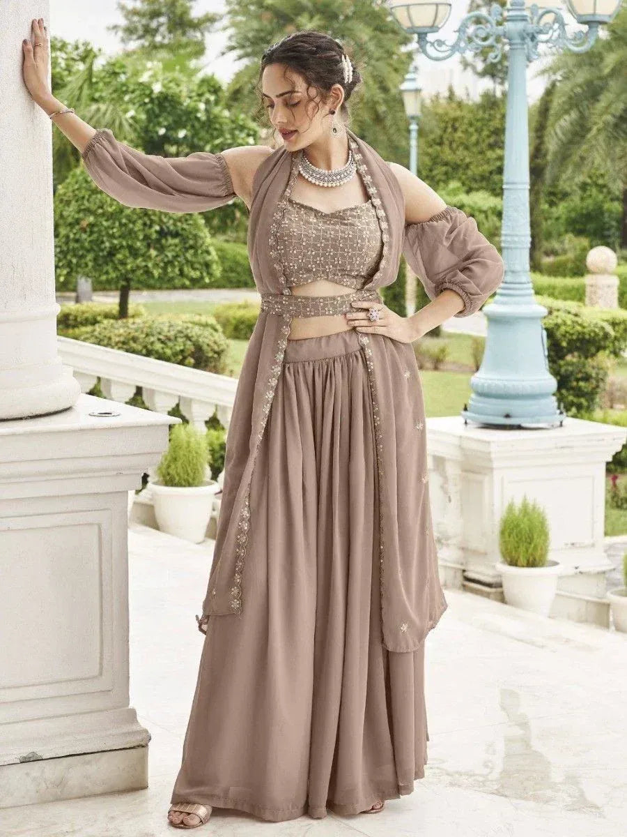 Elegant brown ethnic lehenga choli with sequin top, flared skirt, and dupatta, perfect for Indian weddings or parties.