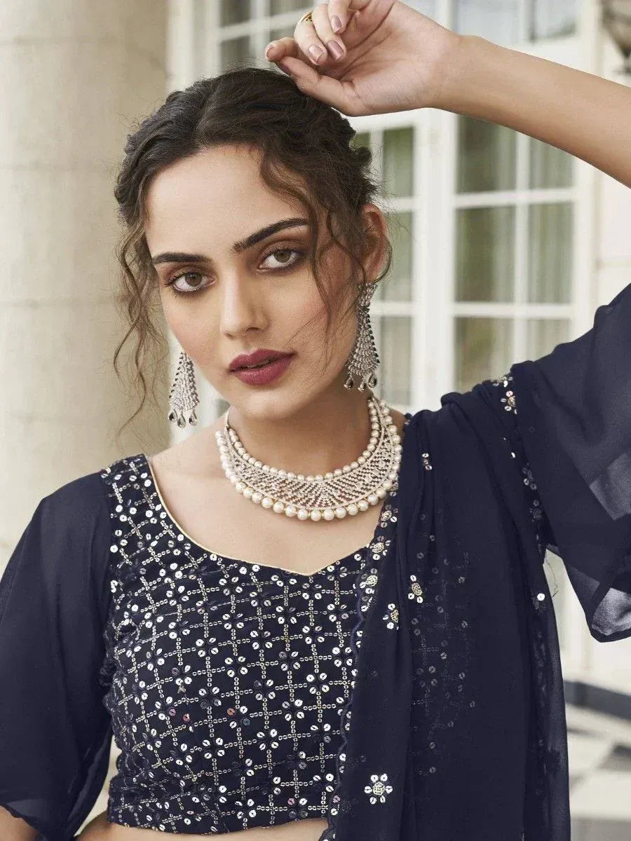 Elegant navy blue sequin blouse with matching dupatta, styled with pearl necklace and jhumka earrings for Indian ethnic wear