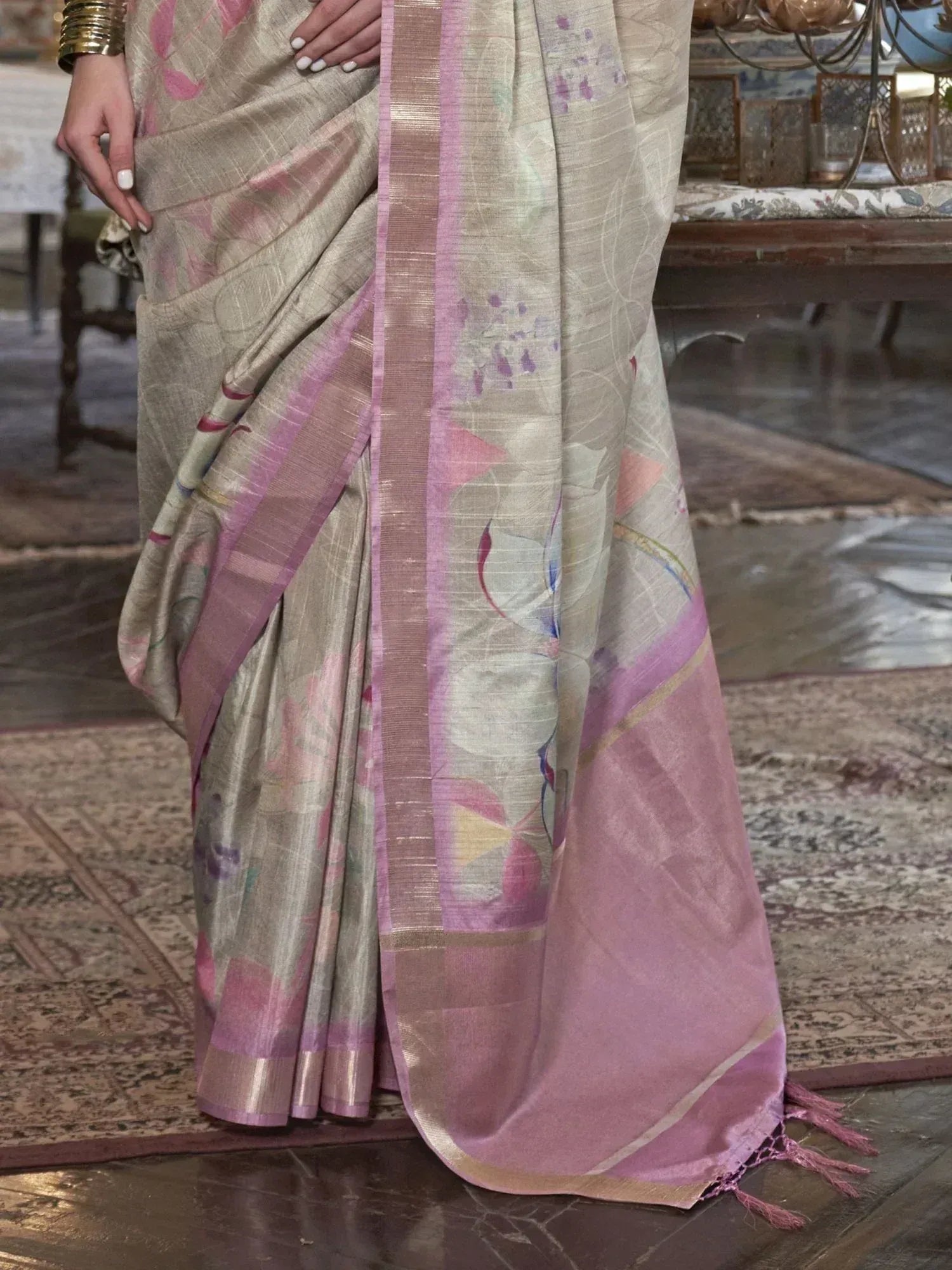 Elegant beige saree with pink floral print and border, perfect for Indian ethnic wear occasions.