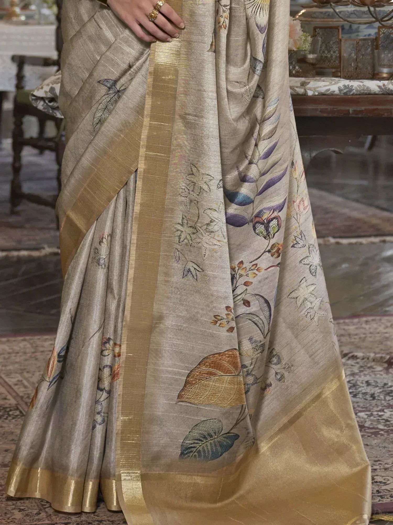 Elegant beige saree with floral leaf print and golden border, perfect for ethnic occasions