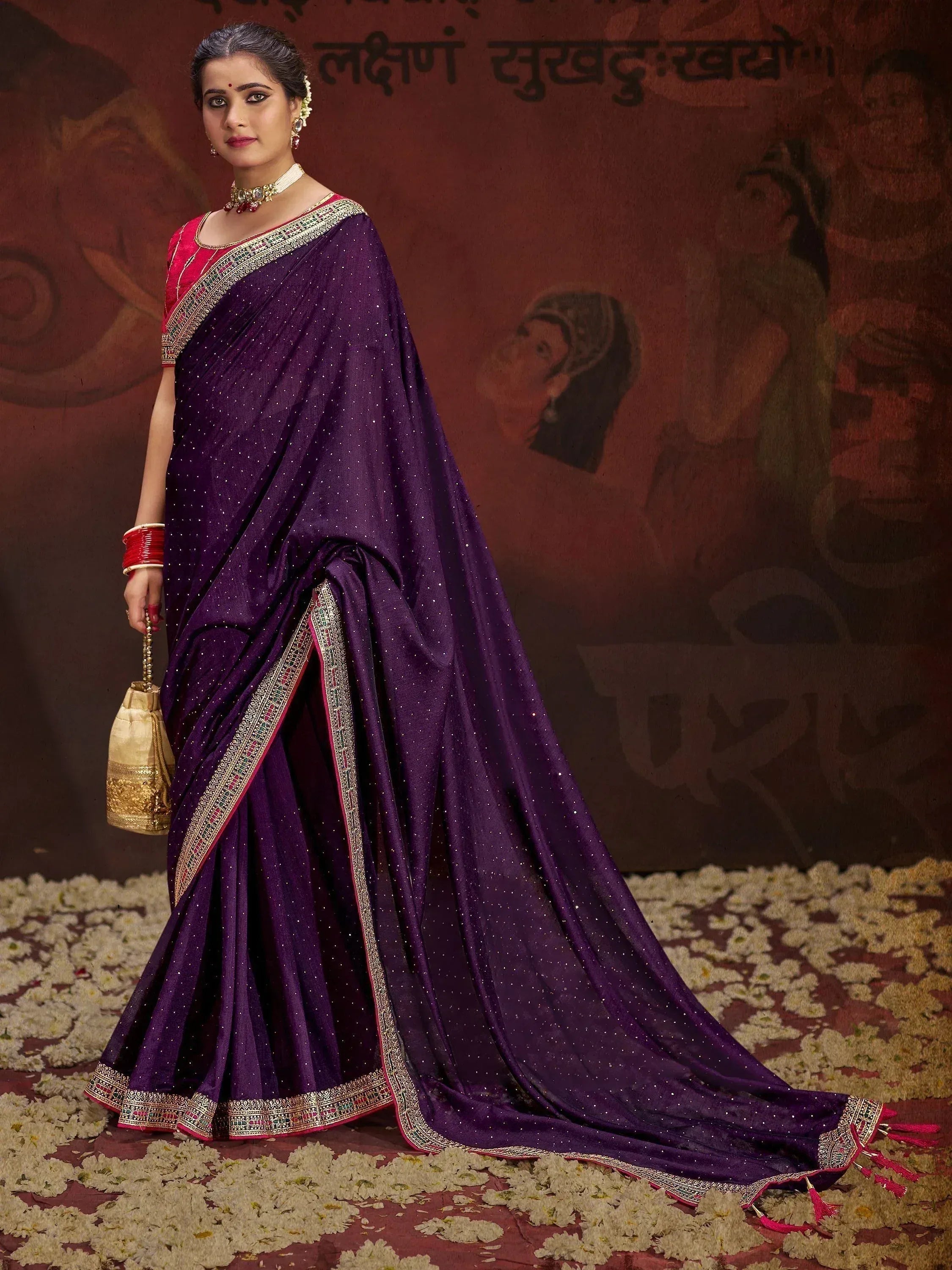Elegant purple ethnic saree with gold embroidery, perfect for Indian weddings and festive occasions.