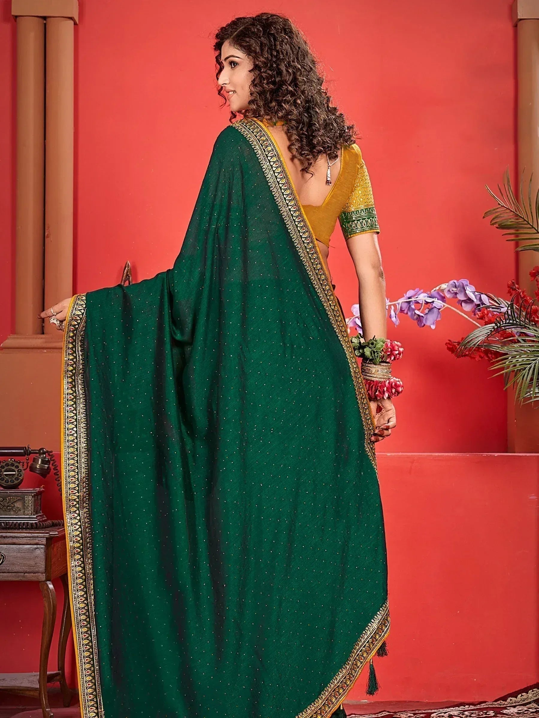 Emerald green saree with gold border and sequin work, paired with yellow blouse, perfect for Indian ethnic occasions