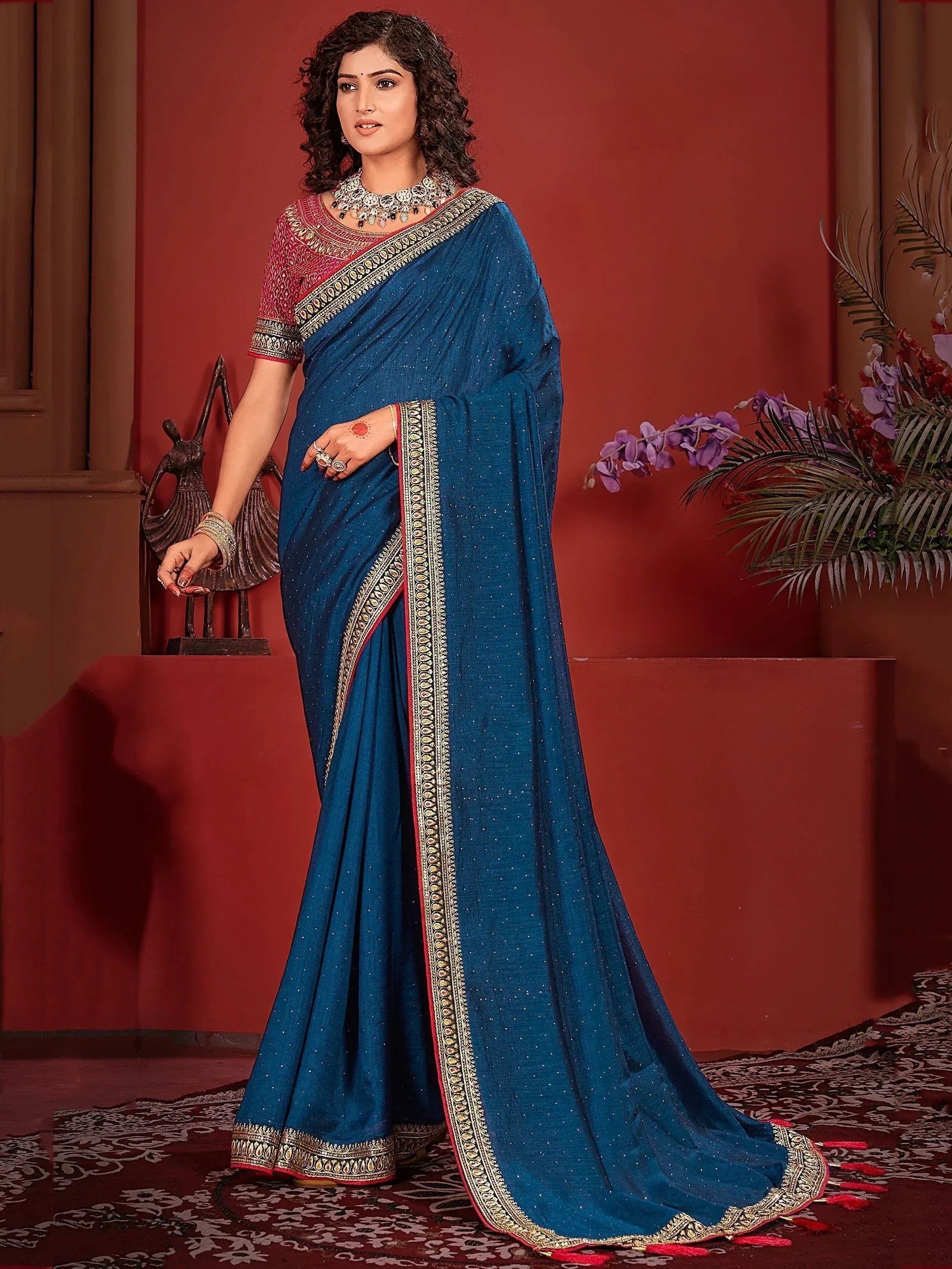 Blue ethnic saree with gold border and red blouse, perfect for Indian weddings and festivals