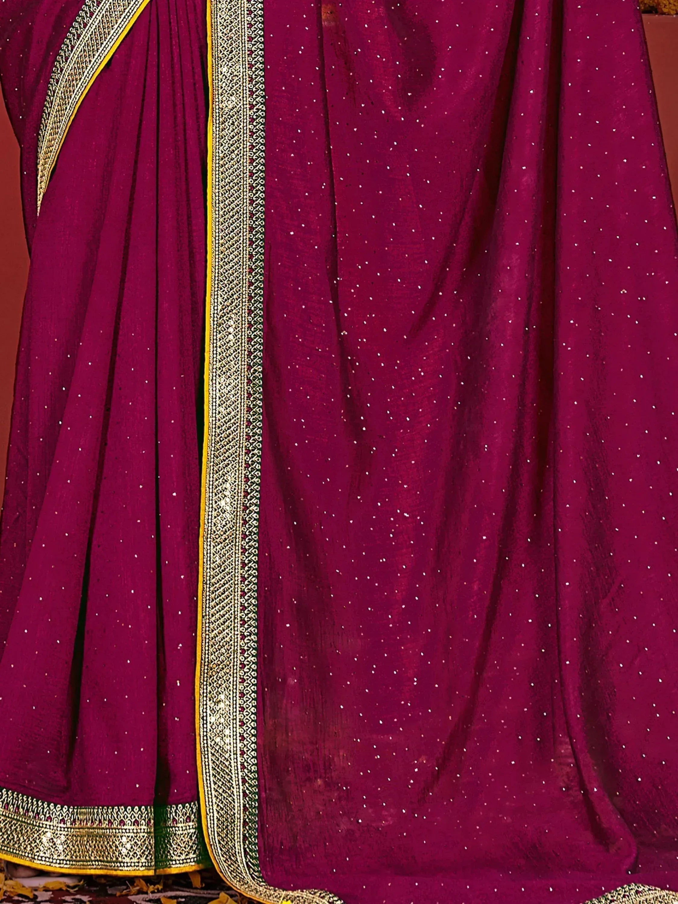 Magenta ethnic saree with gold border and scattered sequins, ideal for Indian celebrations