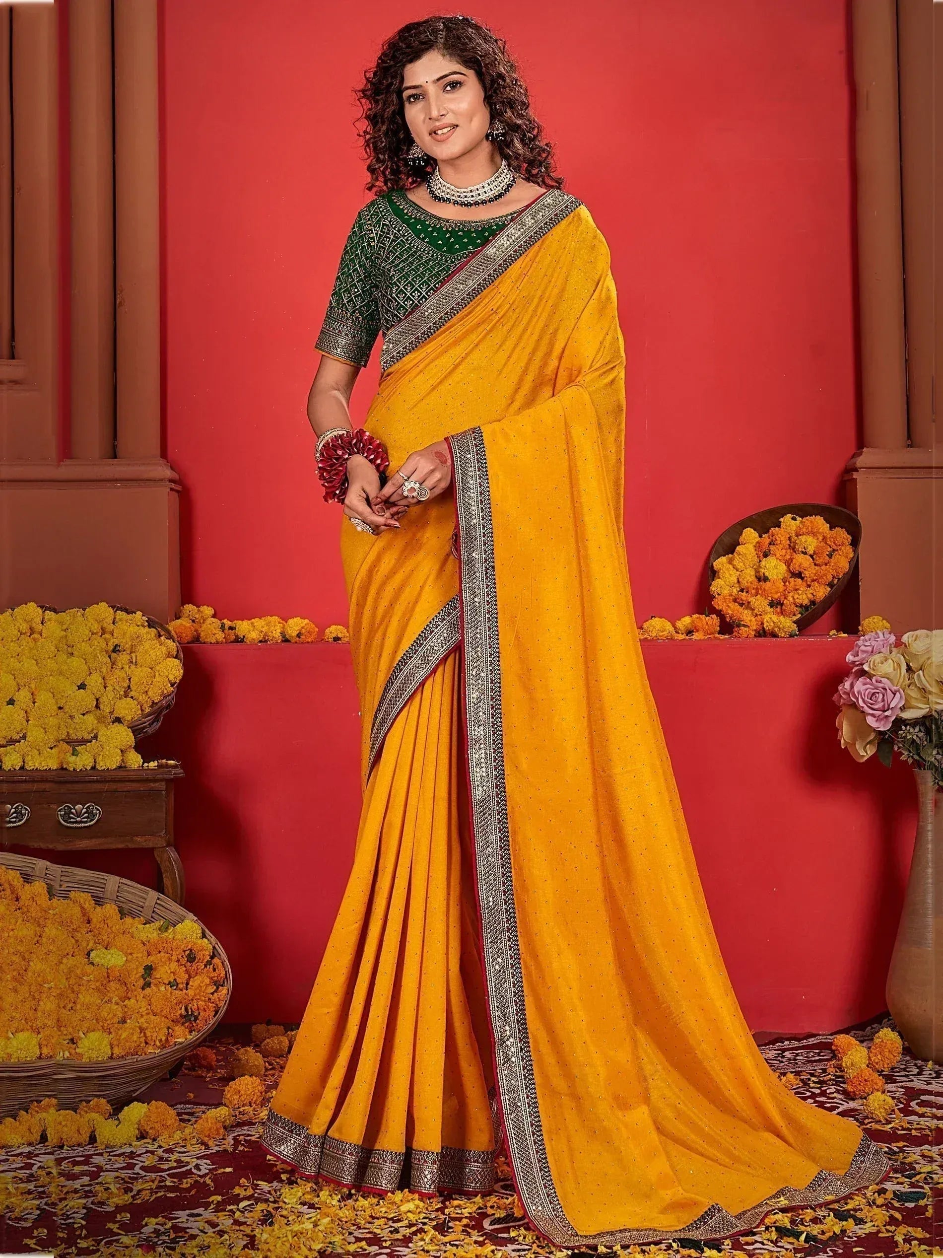 Yellow saree with green blouse, silver border, and floral decor for Indian ethnic wear