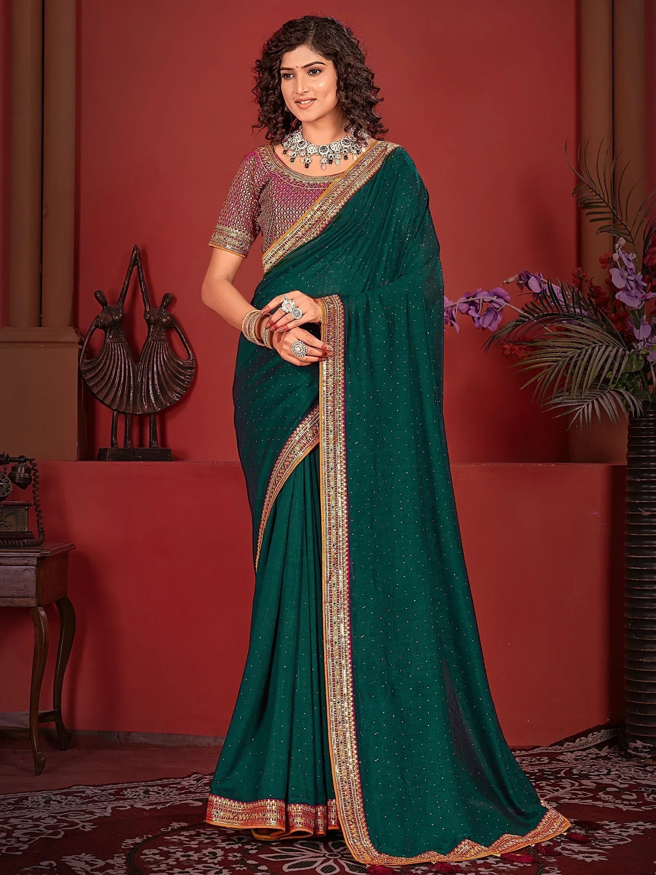 Emerald green saree with gold border and sequin work, paired with embroidered blouse for Indian ethnic wear