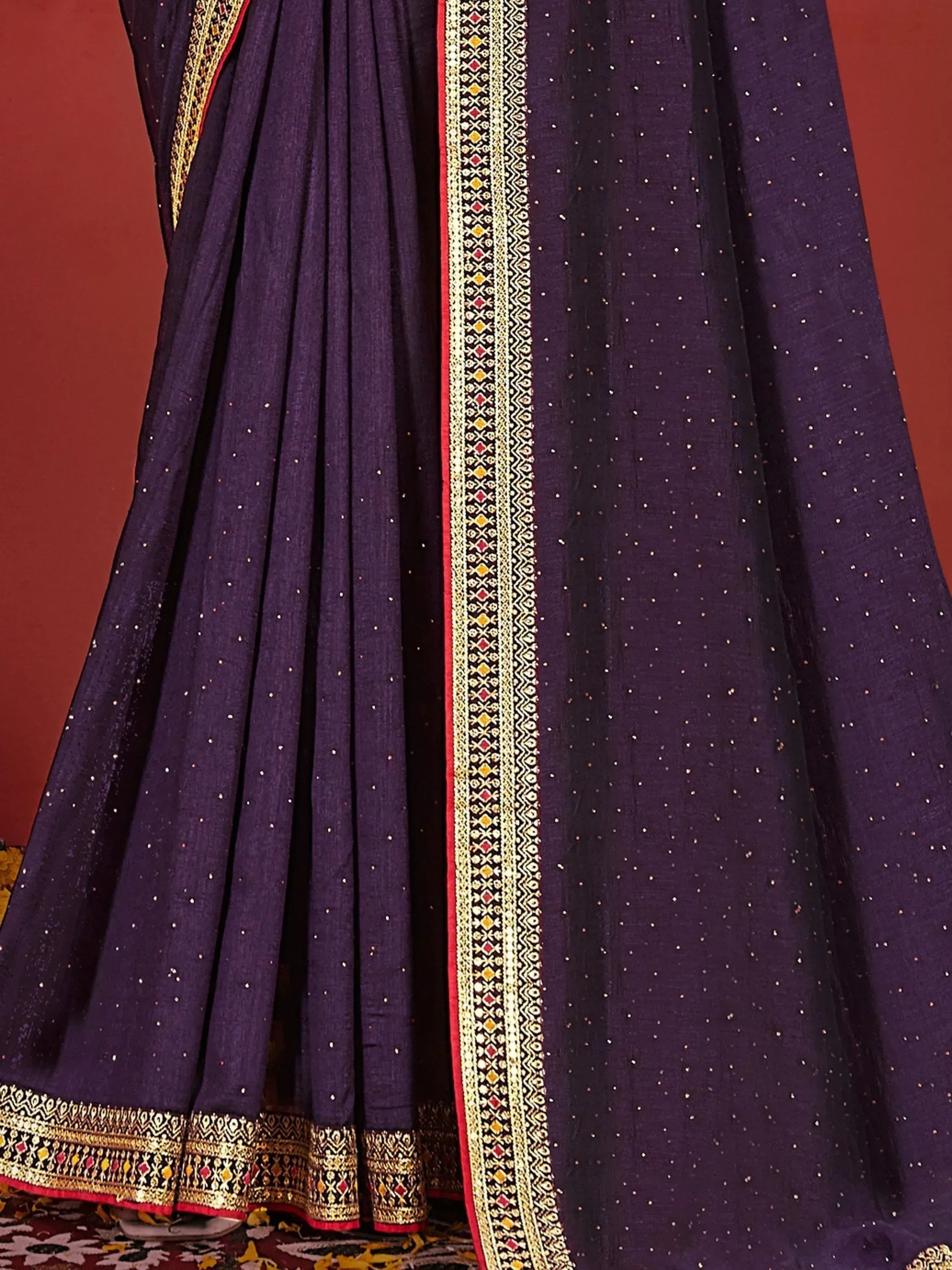 Purple ethnic gown with gold embroidery and sequin detailing, perfect for Indian occasions