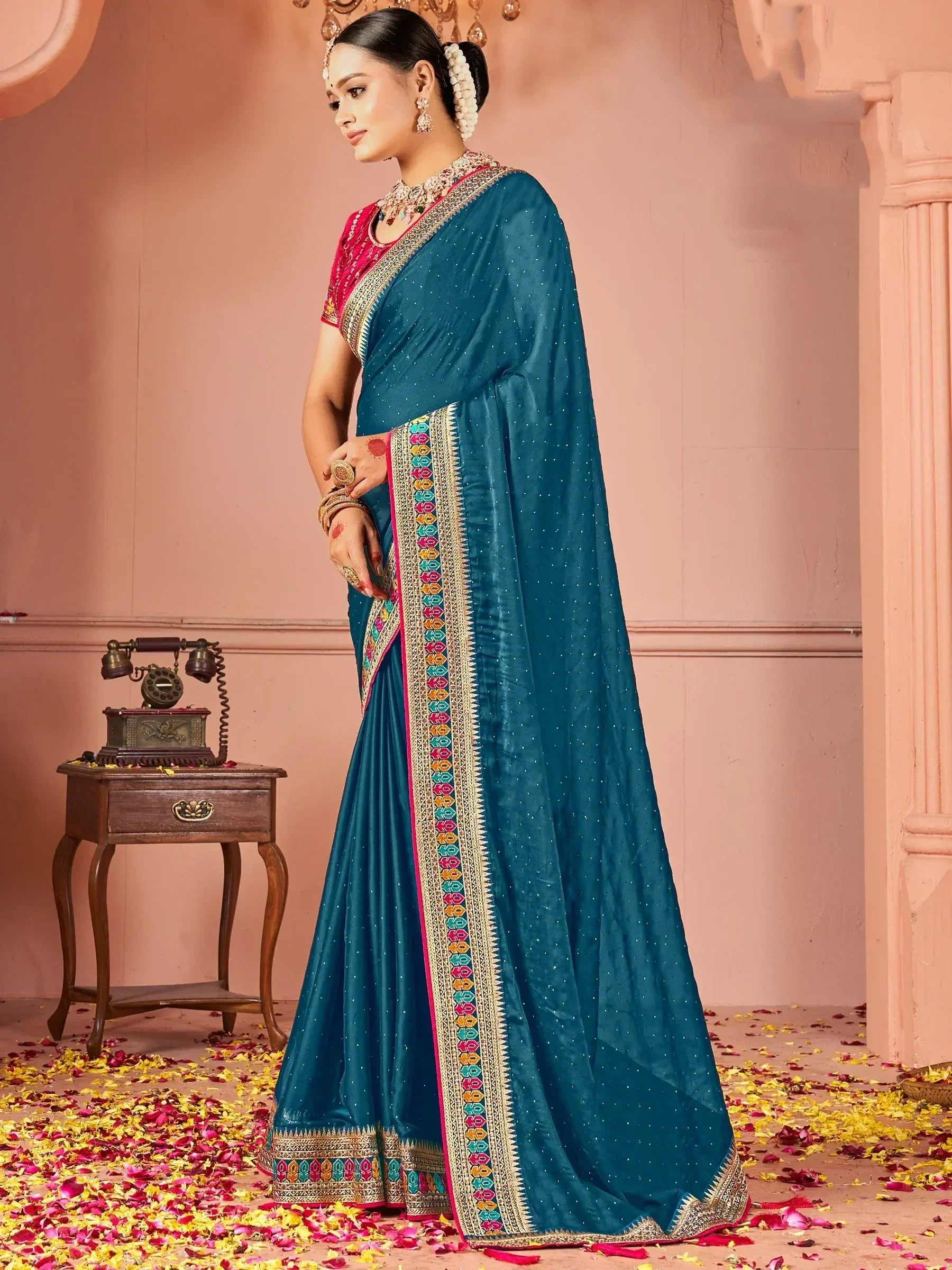 Teal saree with colorful border, perfect for Indian ethnic wear and festive occasions