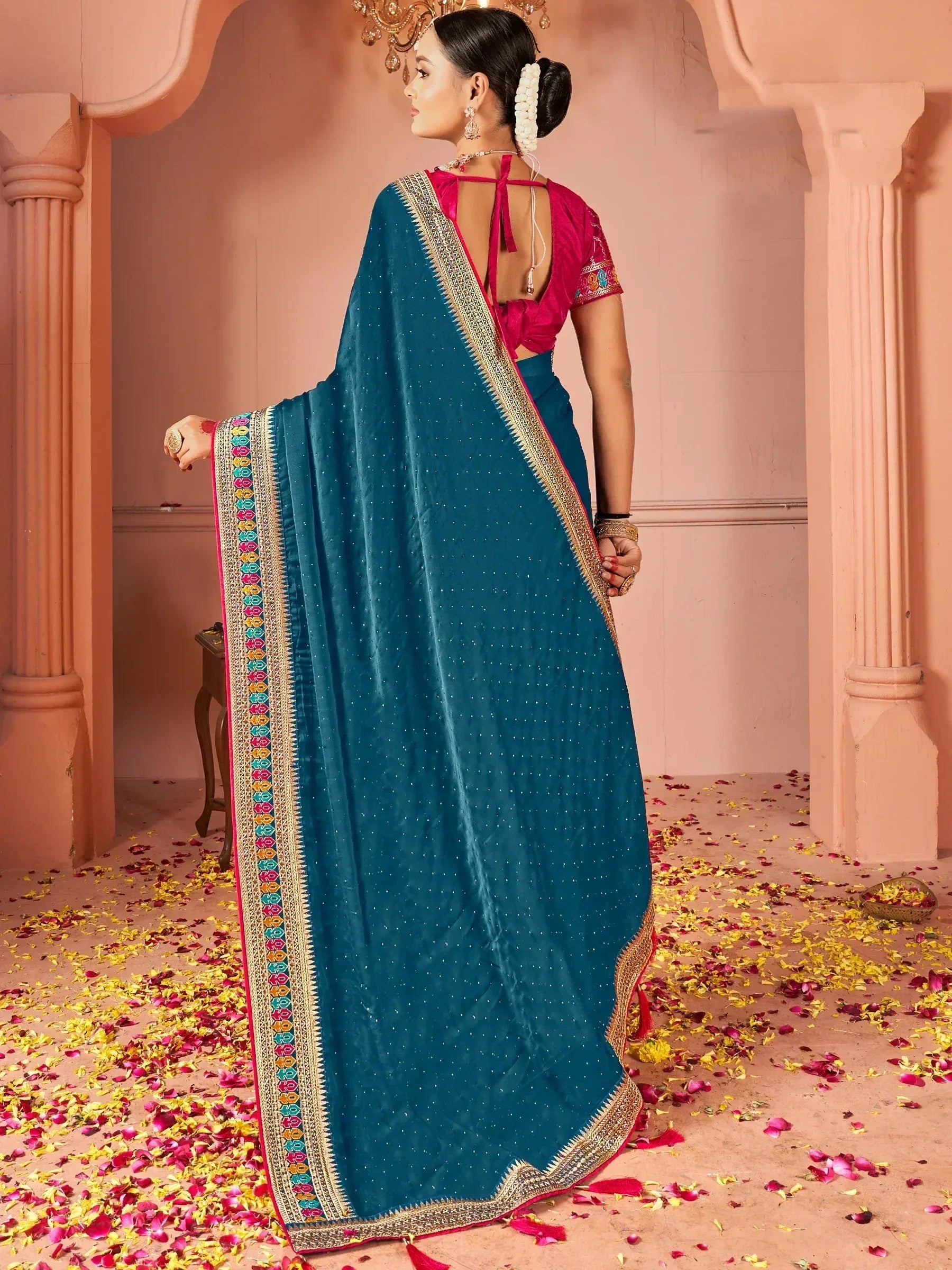 Teal saree with colorful border and pink blouse, styled for ethnic occasions