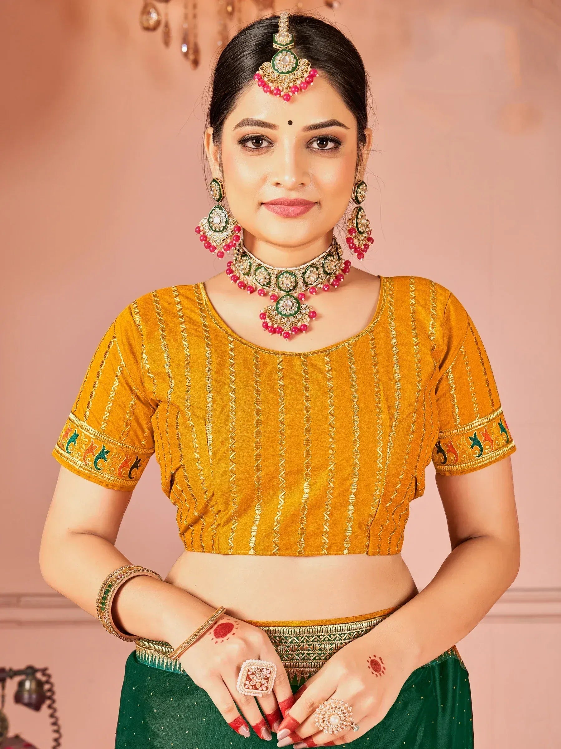 Yellow embroidered blouse with green lehenga, traditional Indian ethnic wear, adorned with jewelry