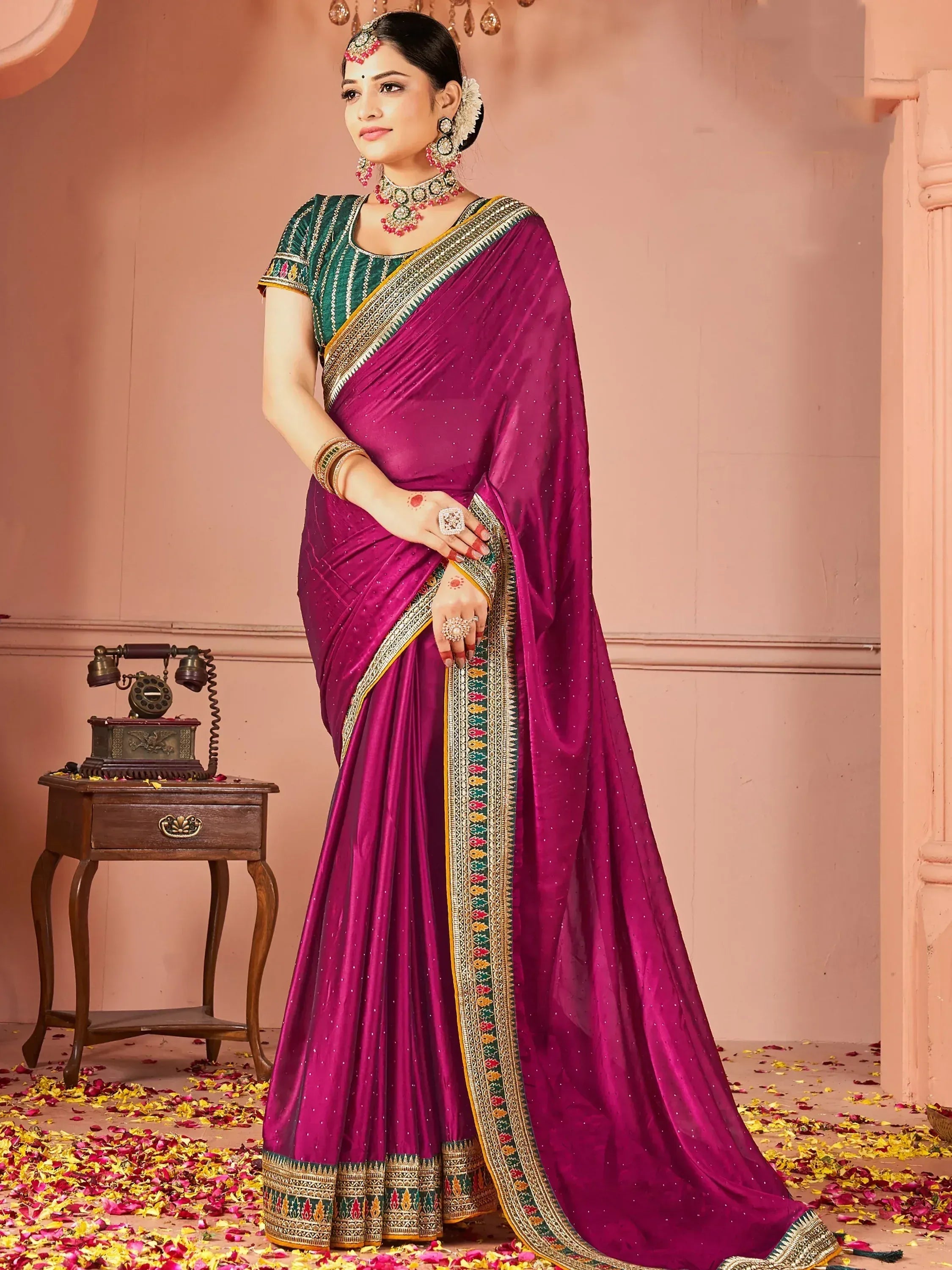 Elegant purple saree with green blouse, intricate border, and traditional jewelry for Indian ethnic wear