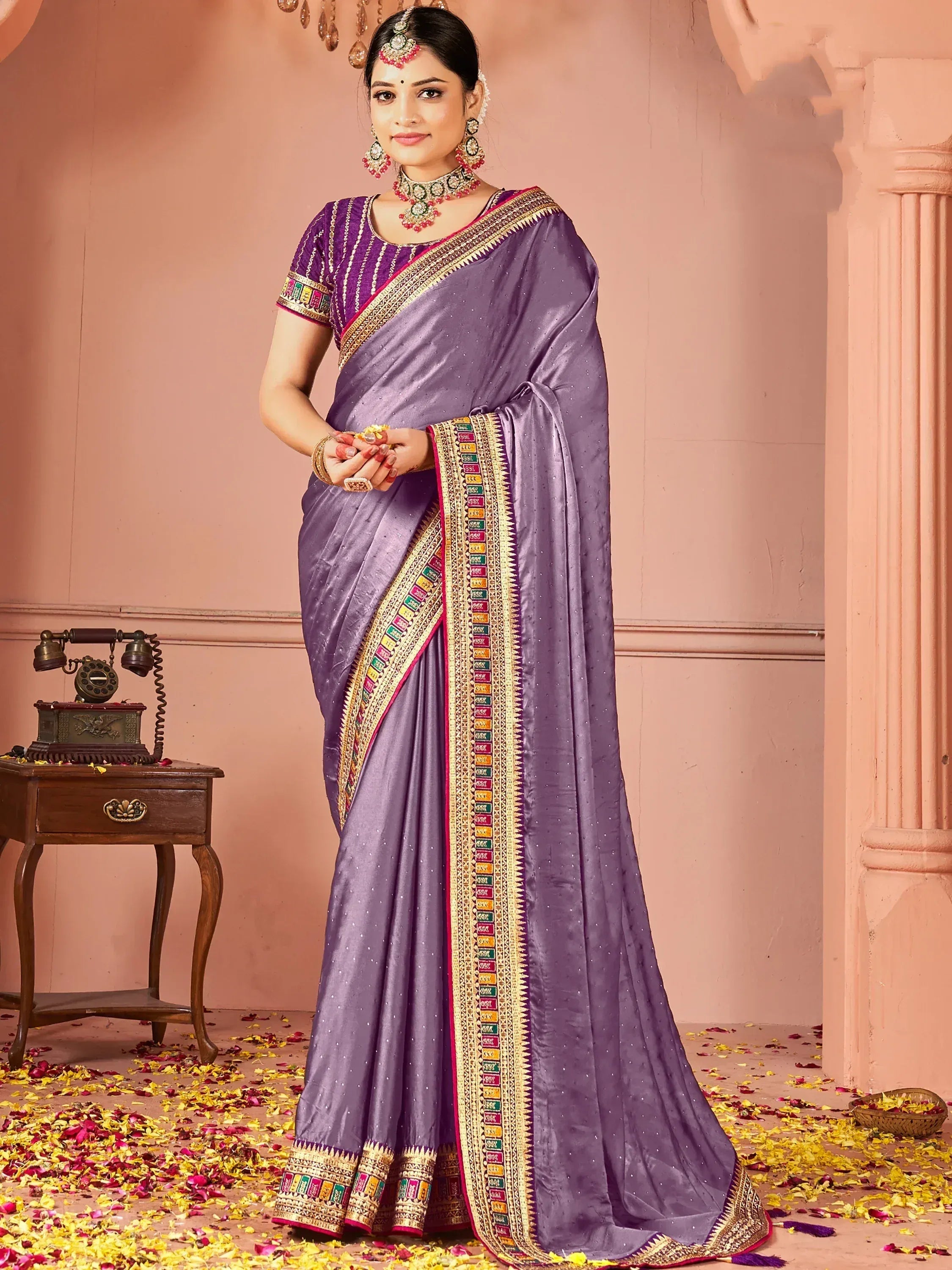 Purple designer saree with gold border and ethnic jewelry for Indian occasions
