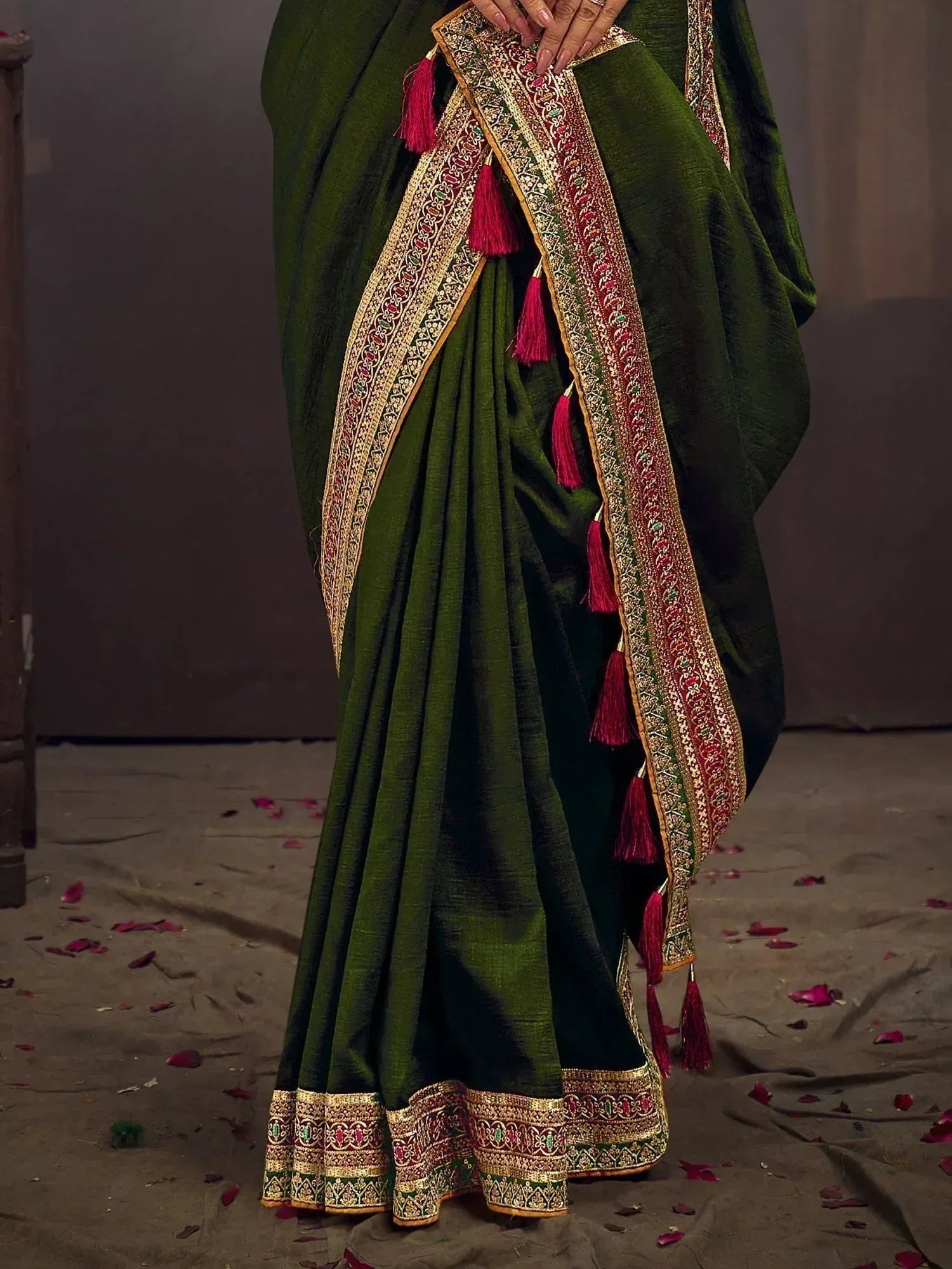 Green ethnic saree with gold red border and tassels, perfect for Indian occasions