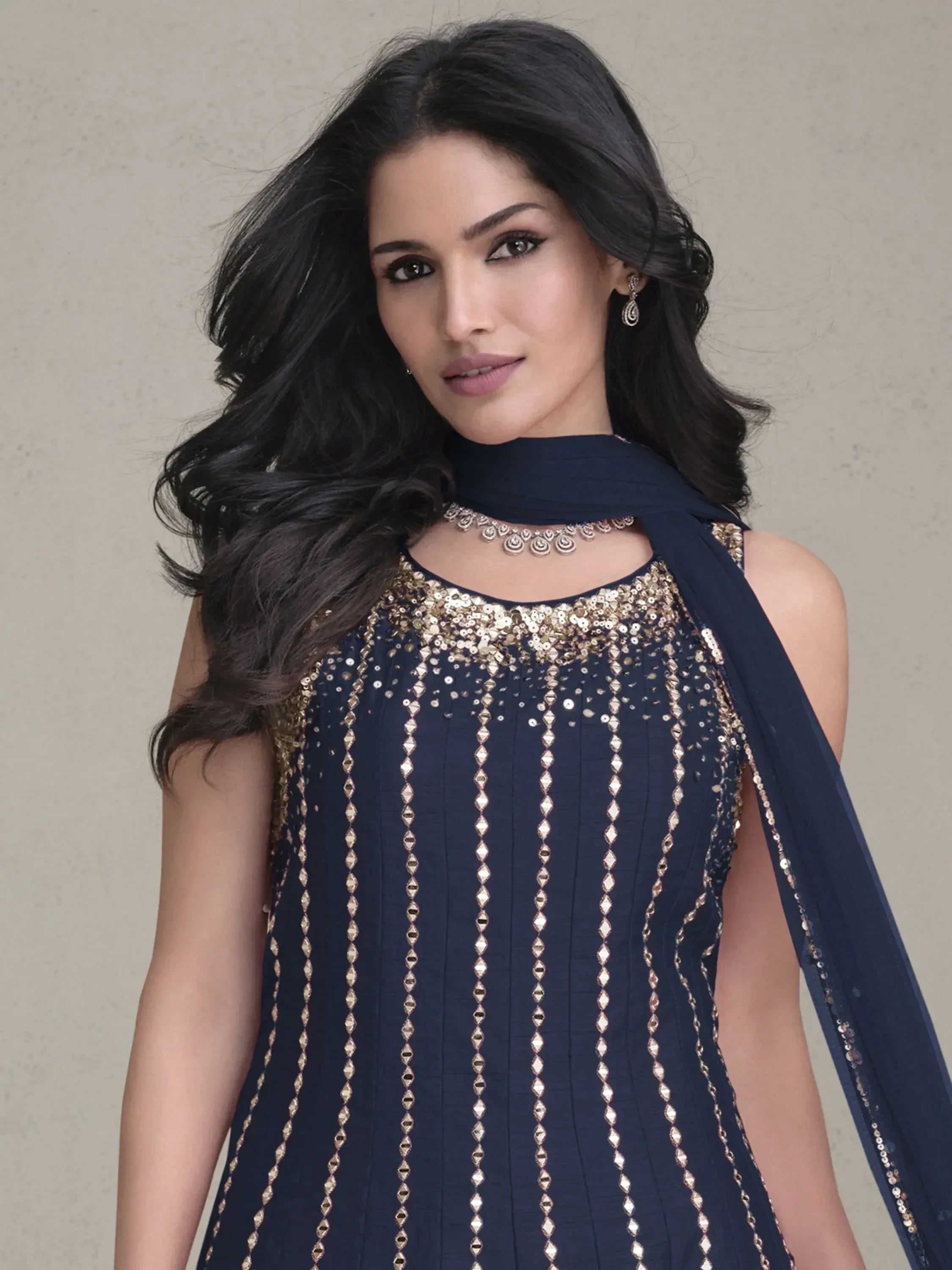 Navy blue ethnic gown with gold sequin embroidery and matching dupatta, perfect for Indian celebrations.