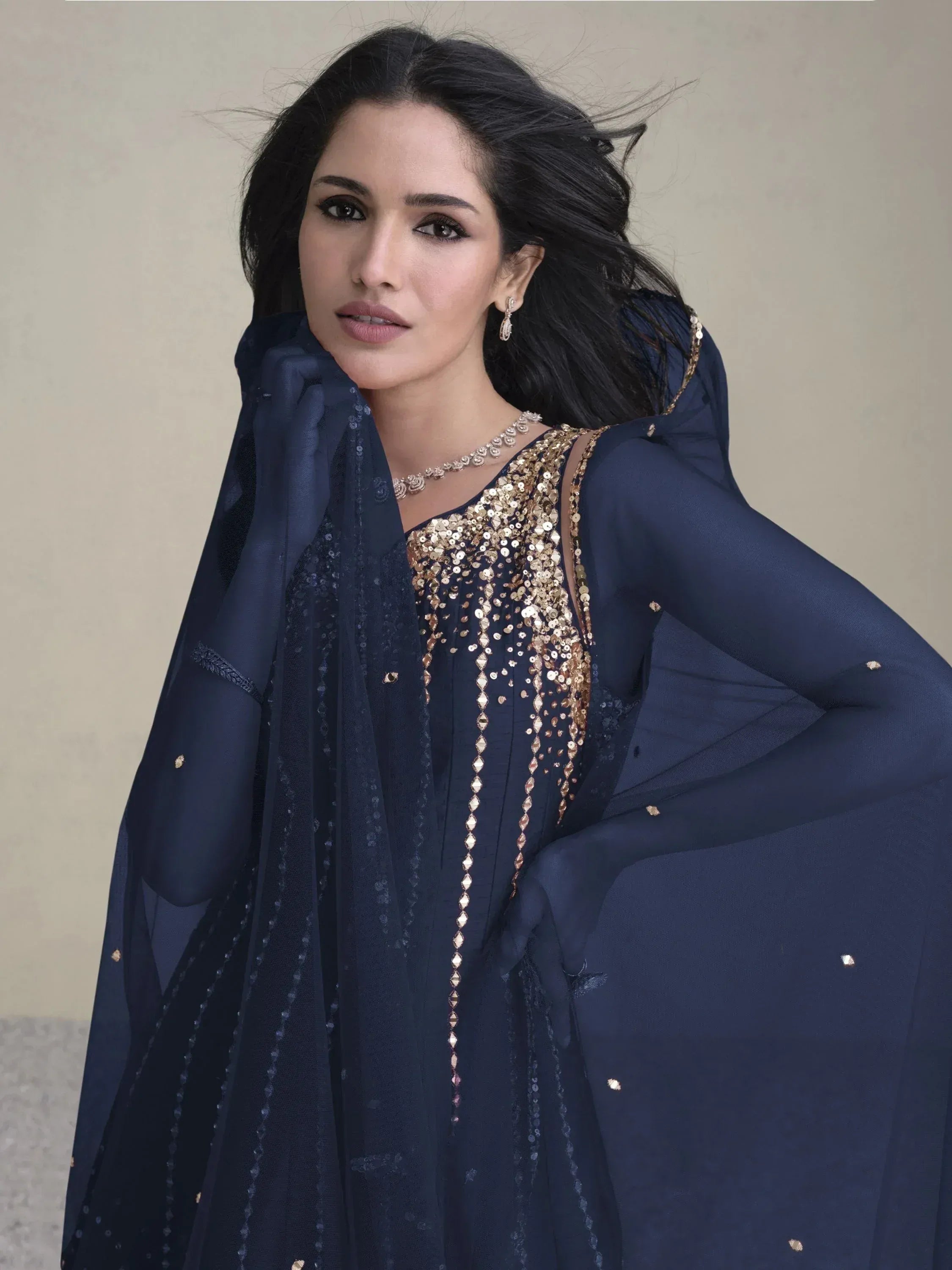 Navy blue ethnic gown with gold sequin embroidery and sheer dupatta, perfect for Indian occasions